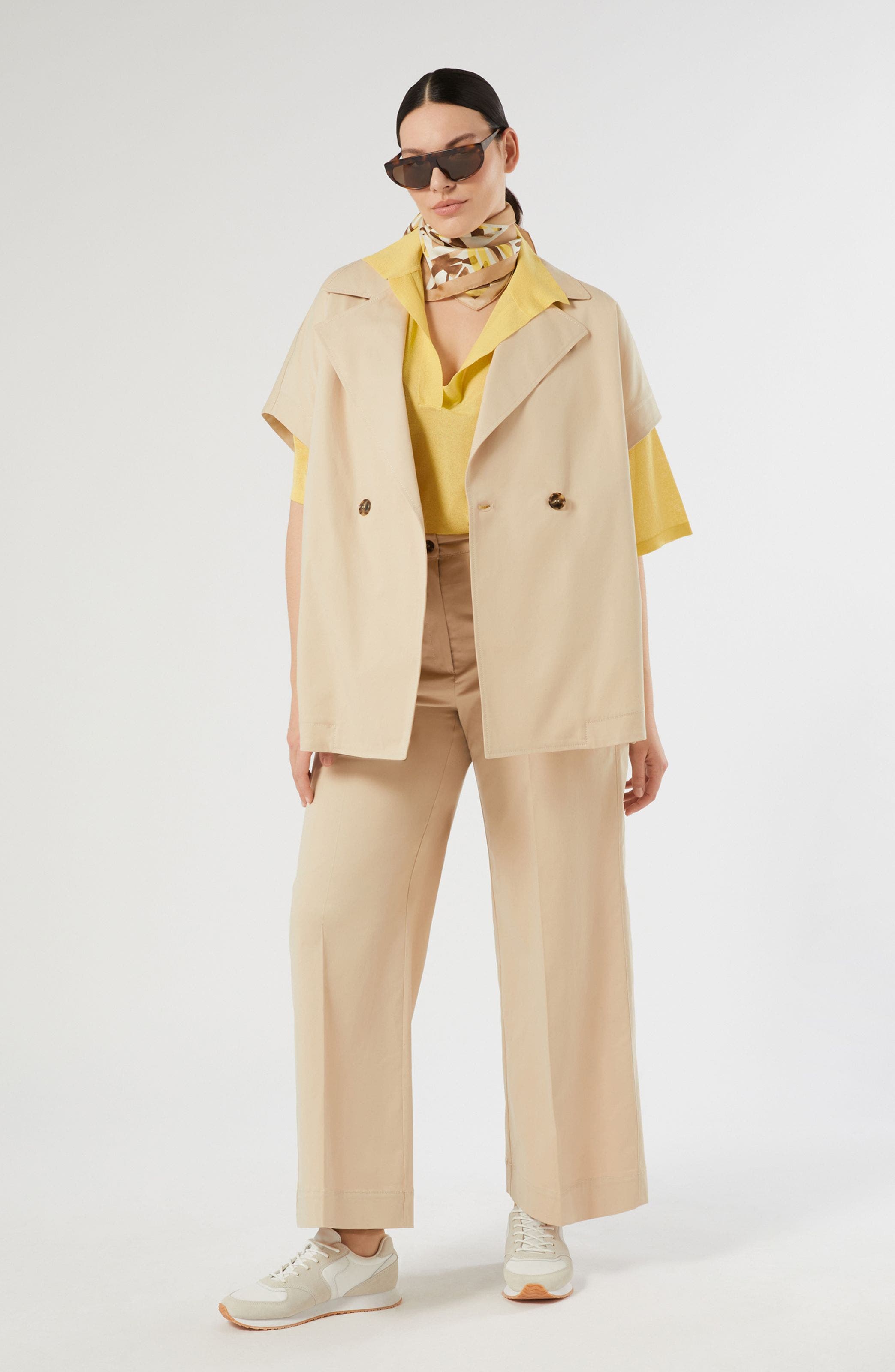 Woman wearing tan short sleeve blazer and matching pants.