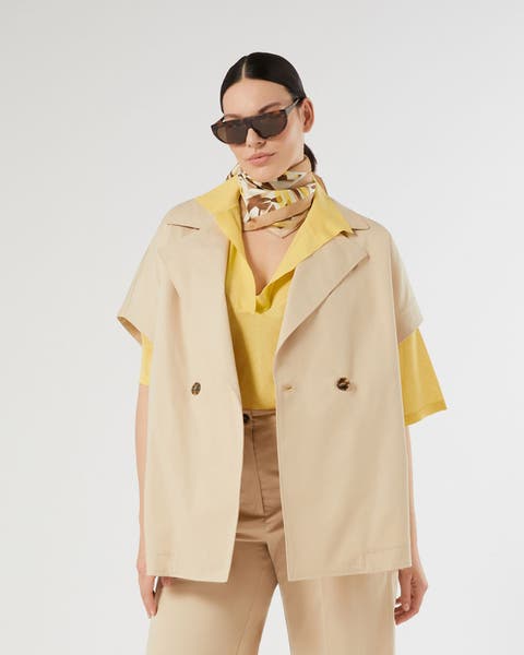 Woman wearing tan short sleeve blazer and matching pants.