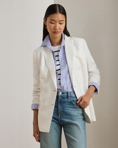 A woman wearing a blazer over a button-up shirt and striped top.