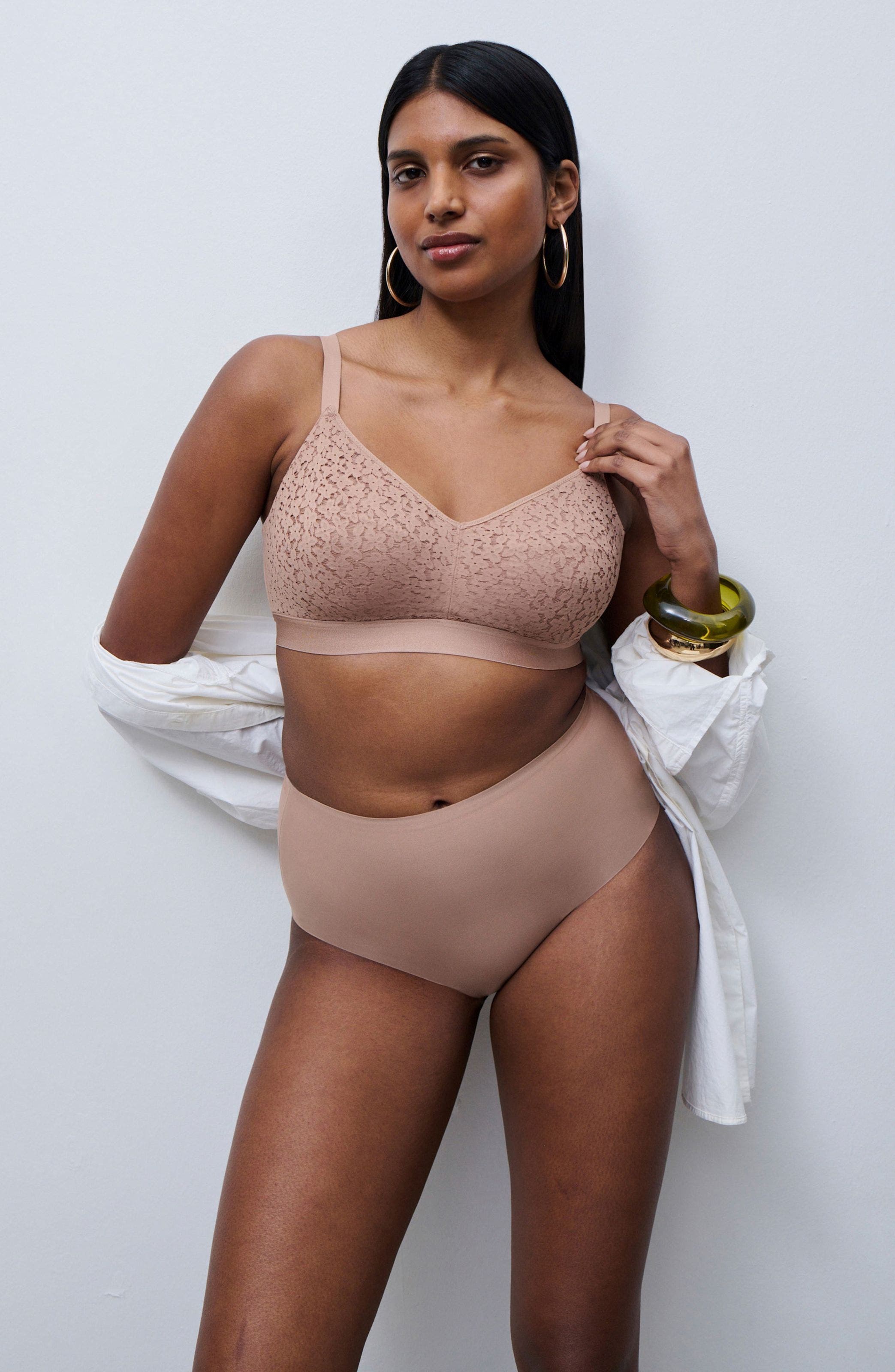 Woman wearing tan wireless bra and tan underwear.