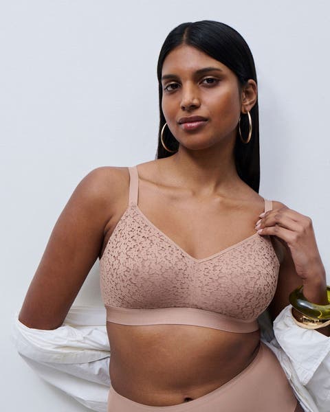 Woman wearing tan wireless bra and tan underwear.