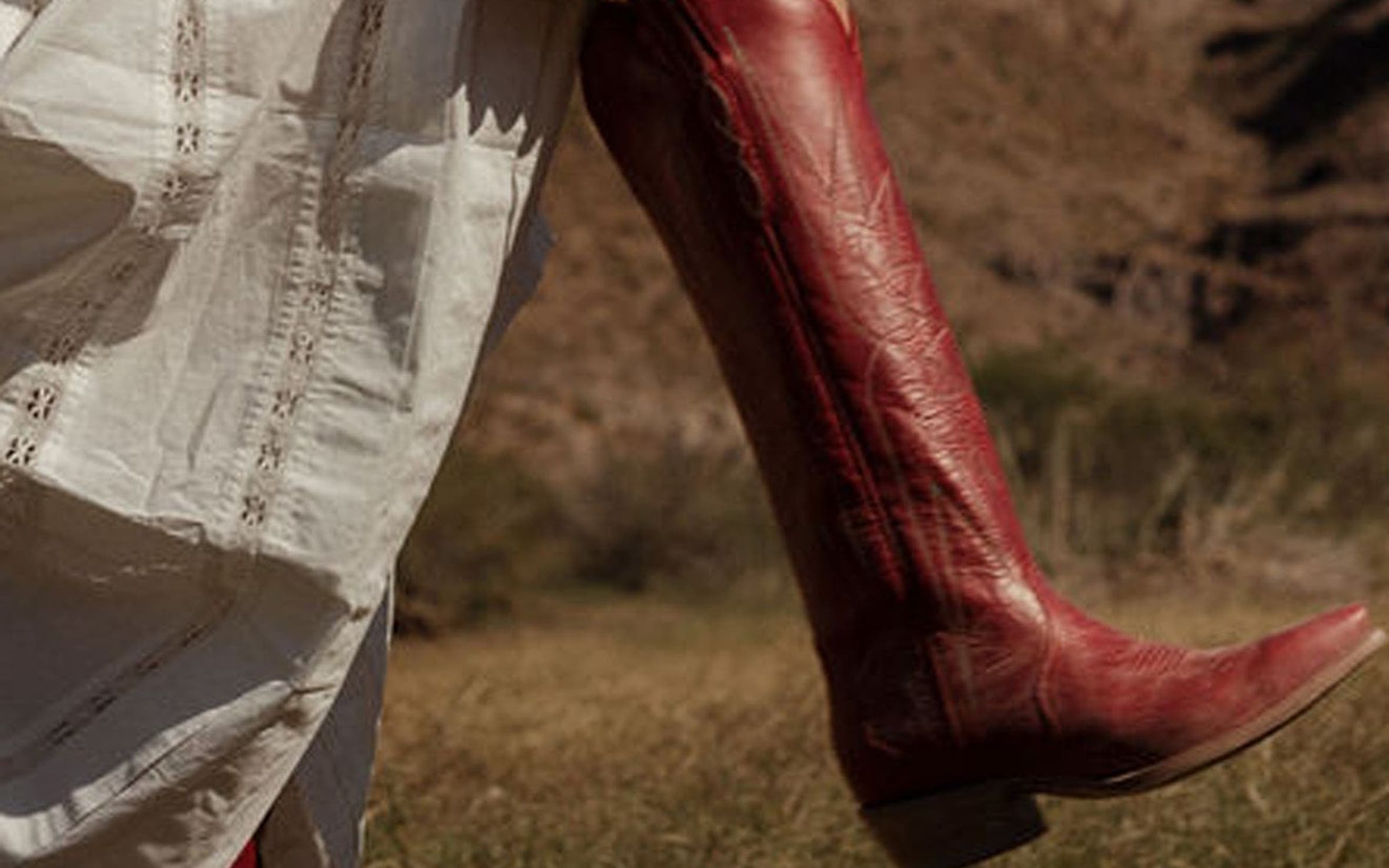 A woman in red knee-high cowboy boots.