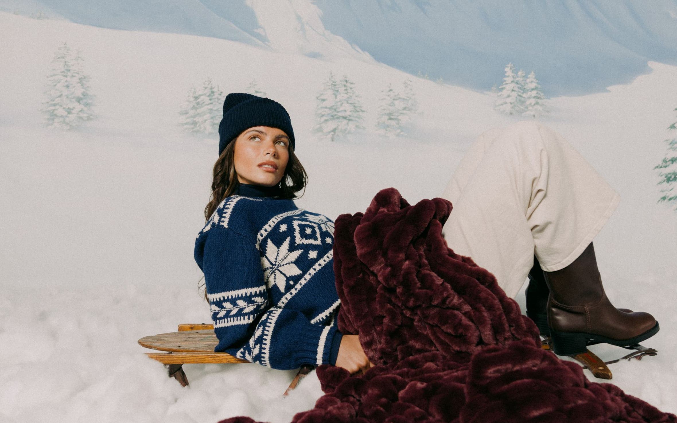 A woman in the snow with a wine colored LOLA BLANKET.