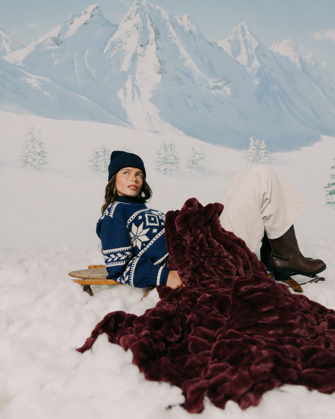 A woman in the snow with a wine colored LOLA BLANKET.