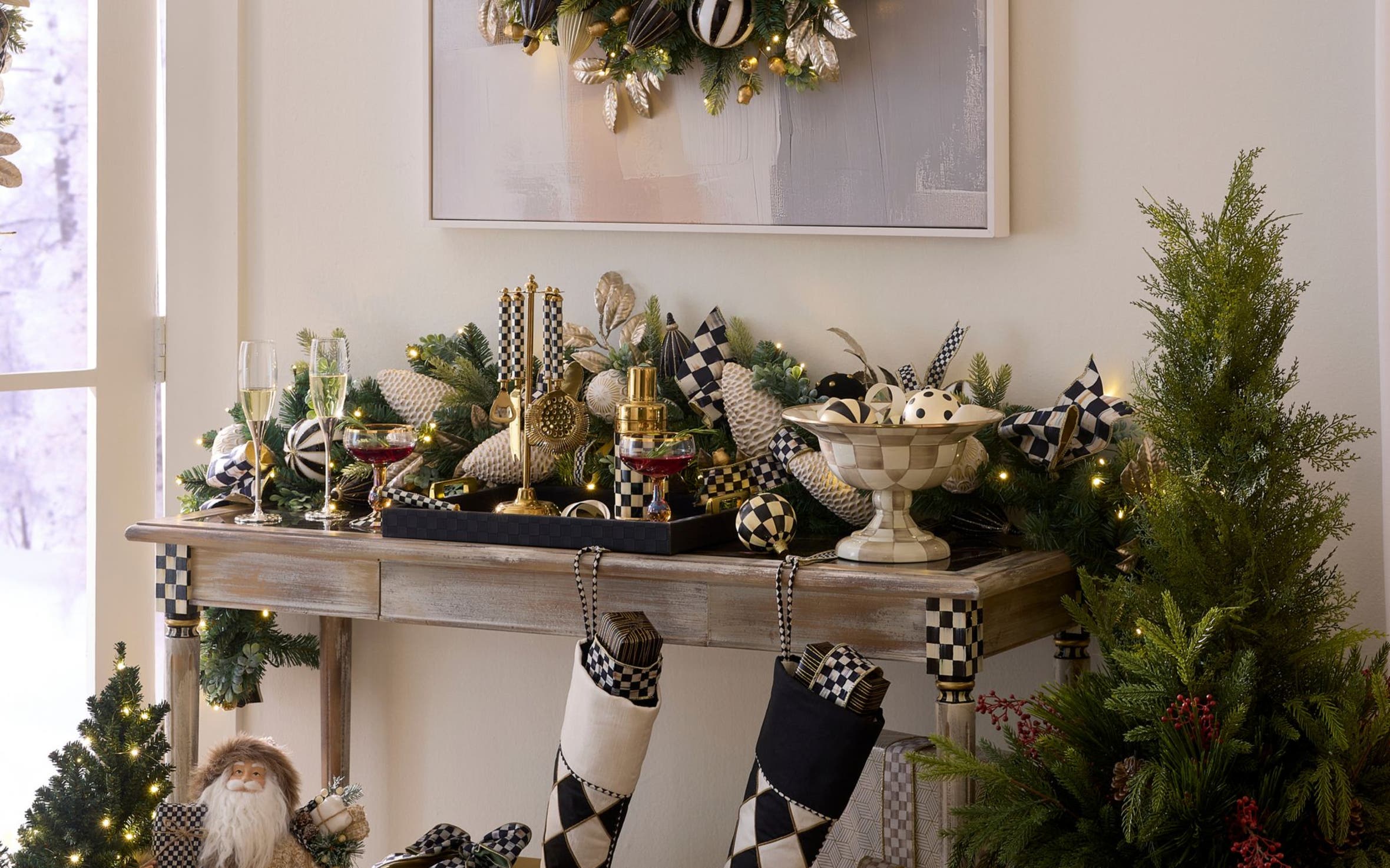 Mackenzie-Childs Courtly Check console table styled with a holiday wreath and black-and-white checkered décor.