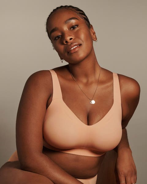 A woman wearing a peach wireless bra.
