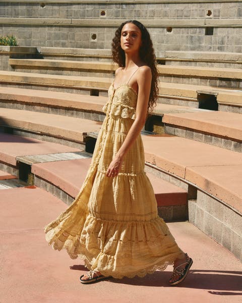 Woman wearing a ruffled maxi dress.