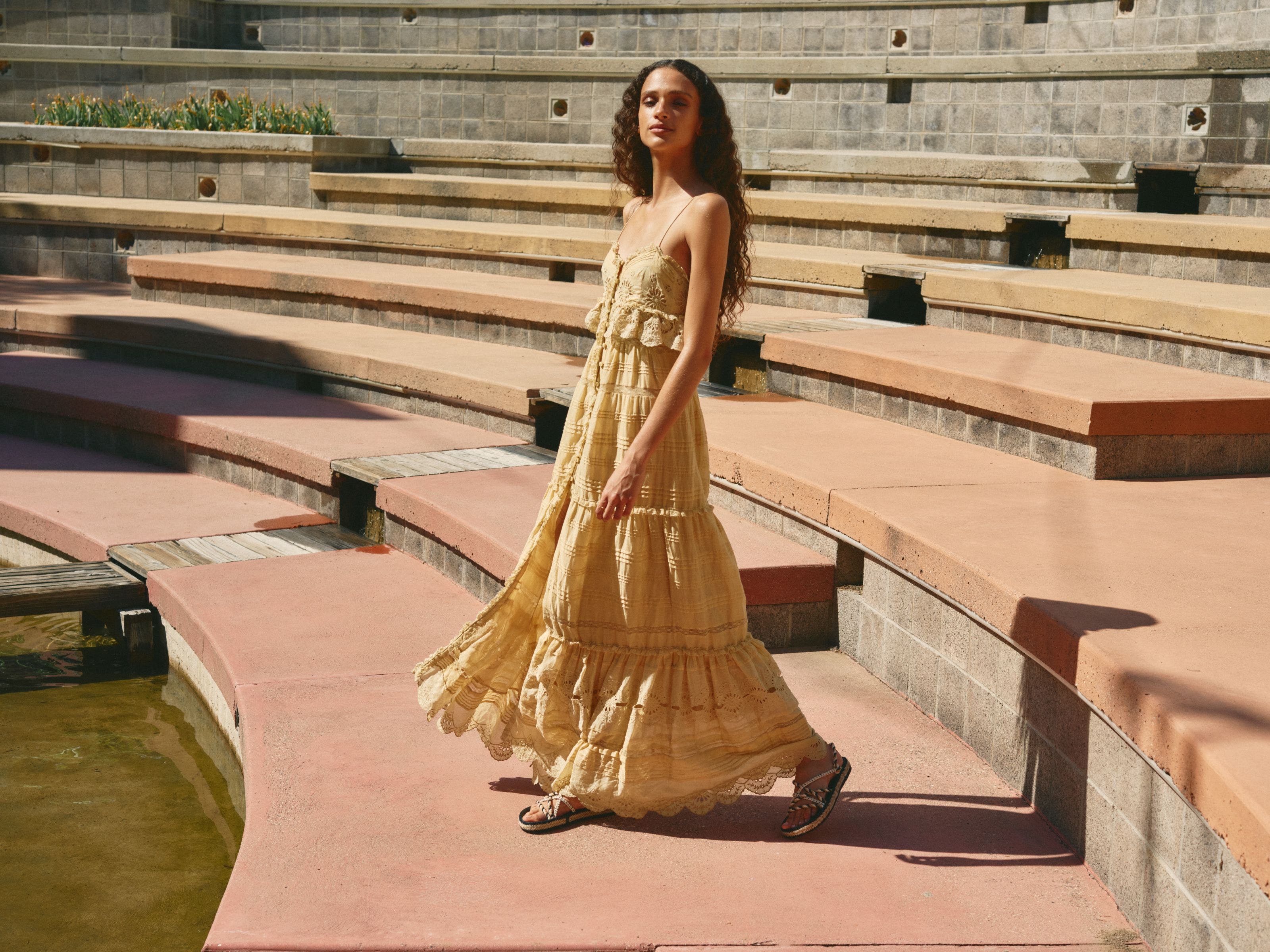 Woman wearing a maxi dress and sandals.