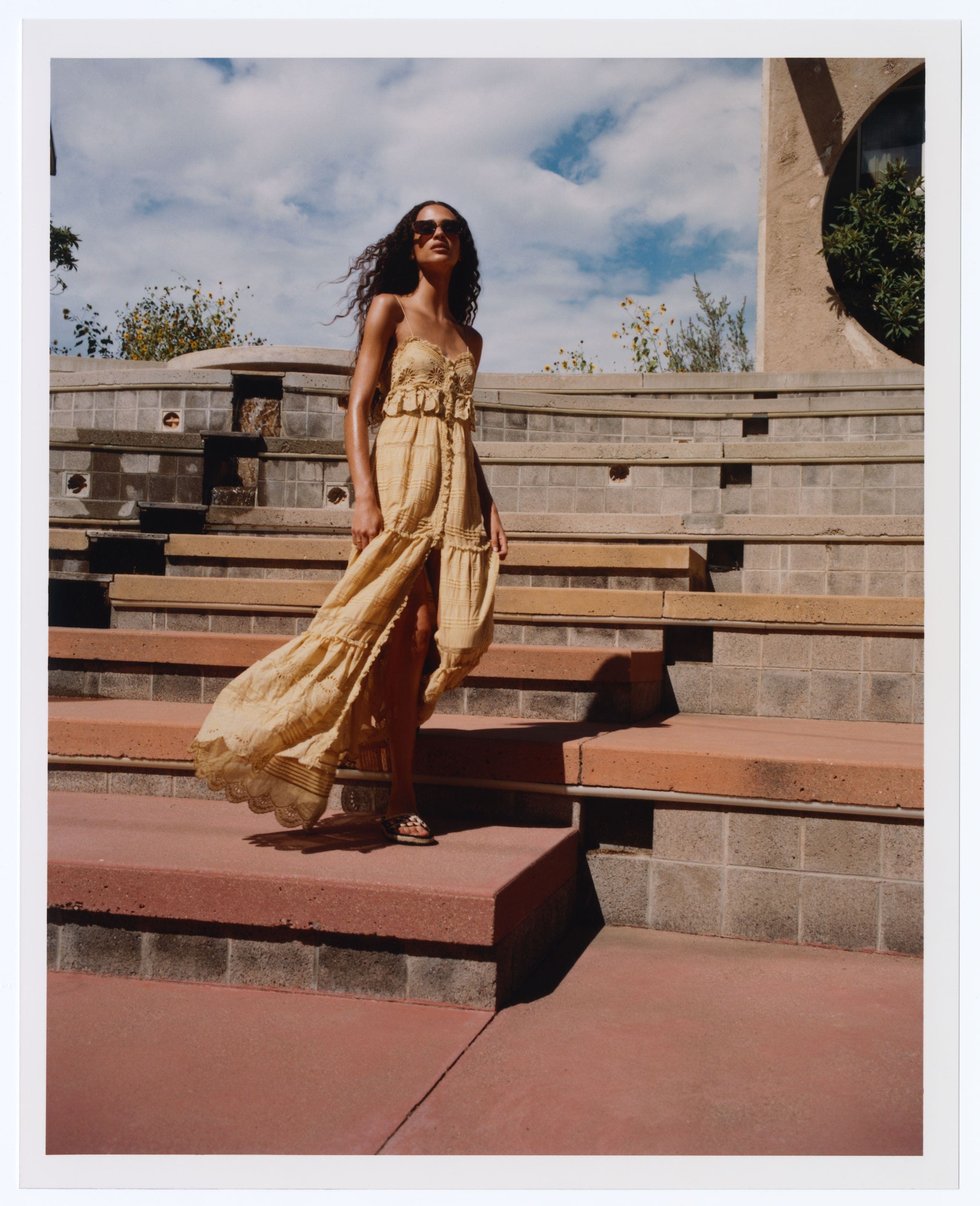 Woman wearing a lace, tiered dress.