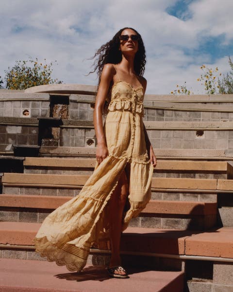 Woman wearing a lace, tiered dress.