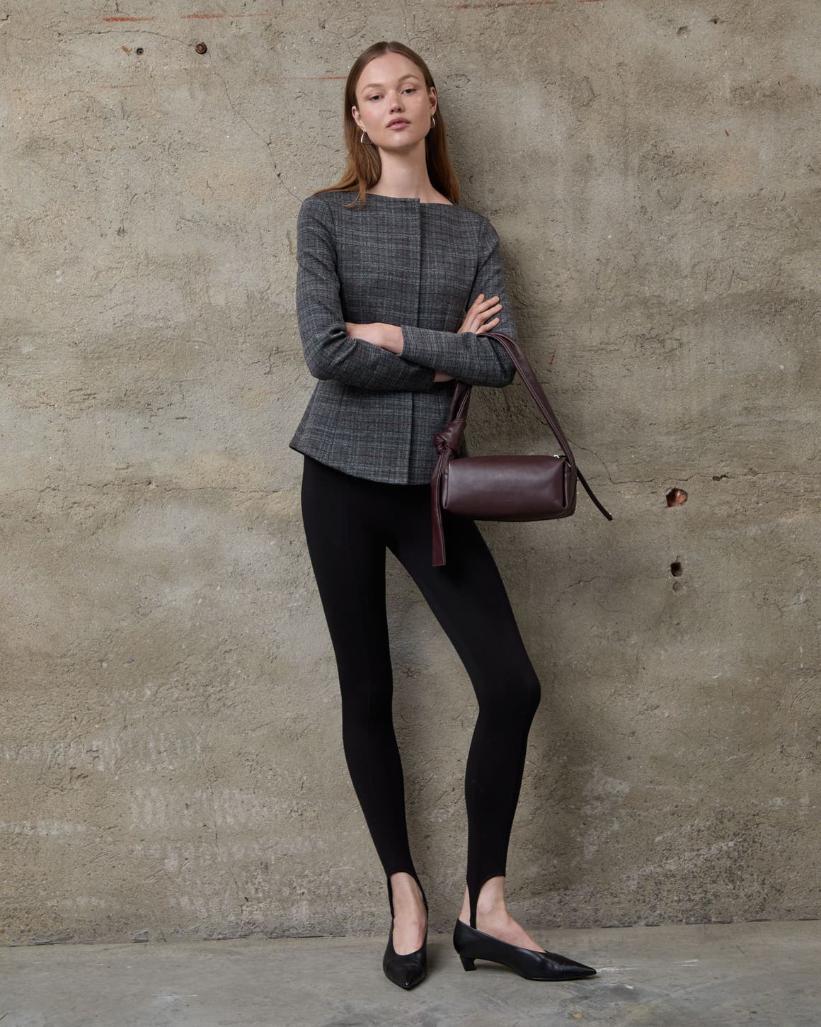 A woman wearing a blazer and trousers.