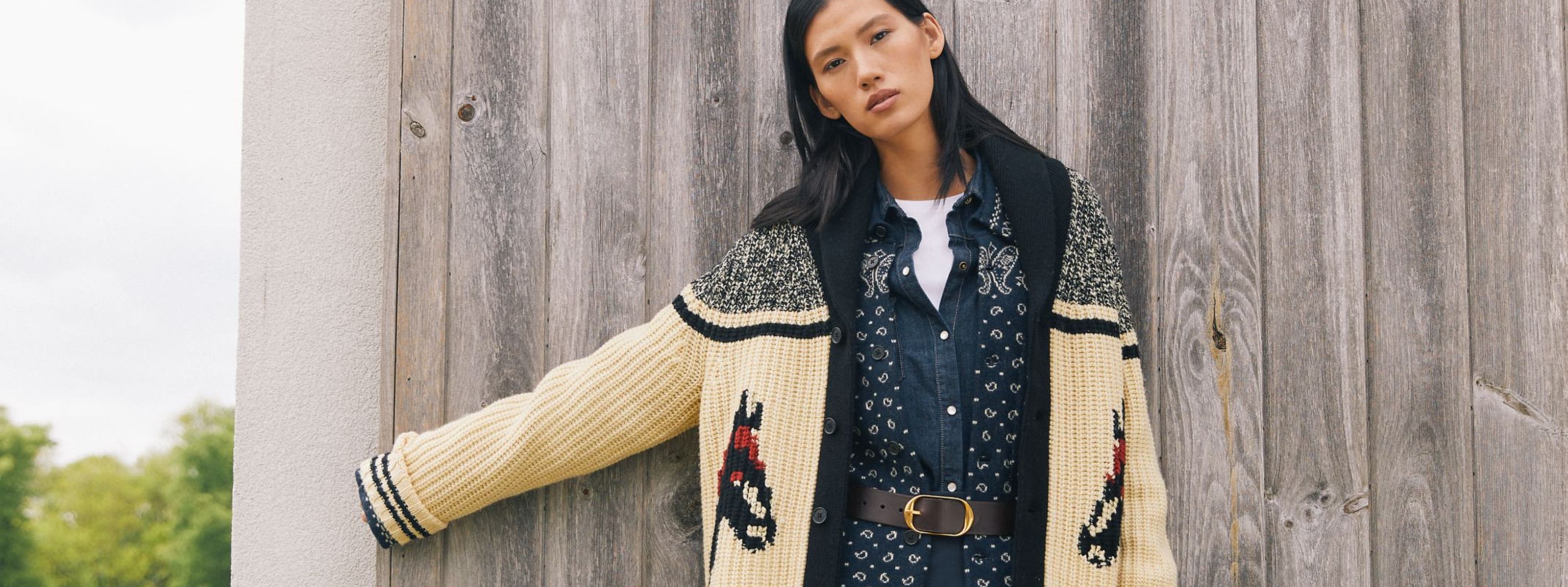 Woman wearing a patterned cardigan.