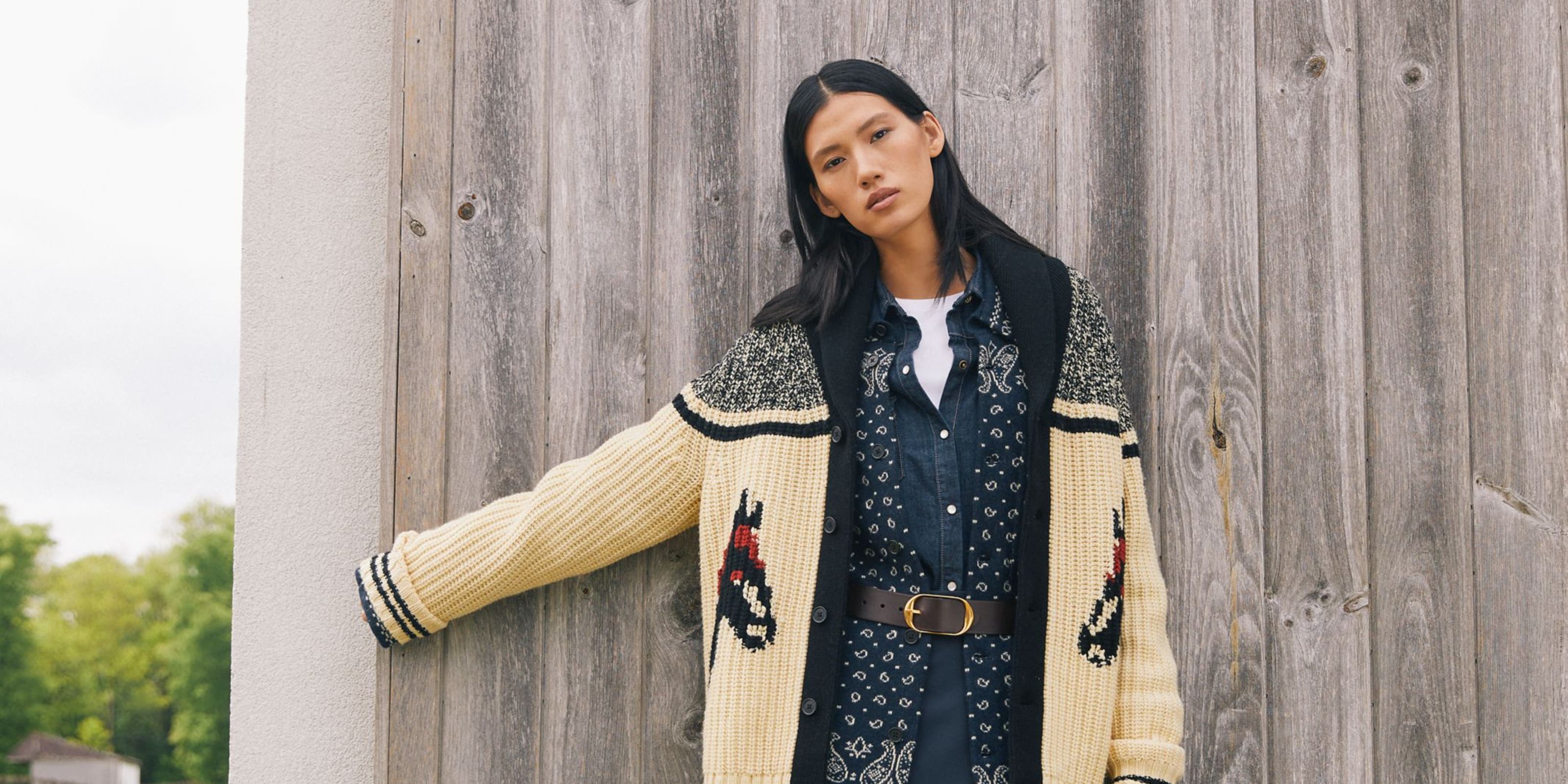 Woman wearing a patterned cardigan.