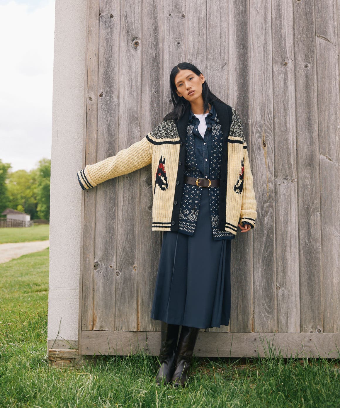 Woman wearing a patterned cardigan.
