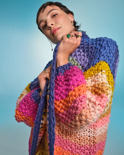 A woman in a chunky cardigan.