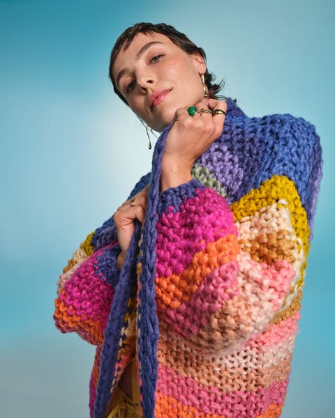 Woman in colorful cardigan.