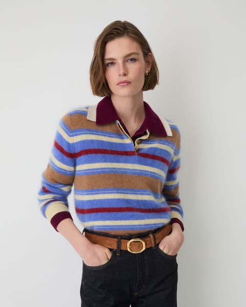 A woman in multicolor striped polo sweater.
