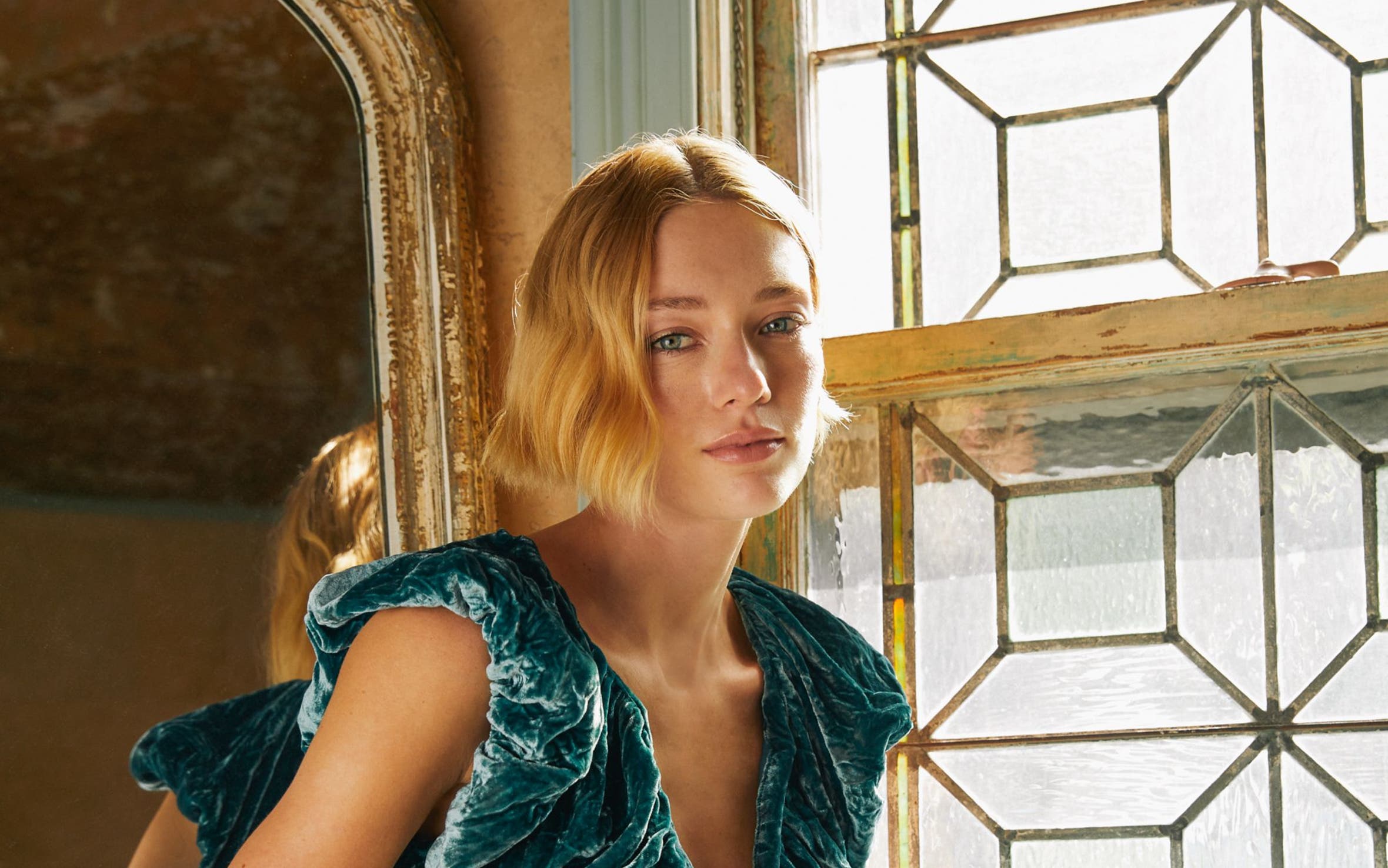 A woman wearing a velvet dress.