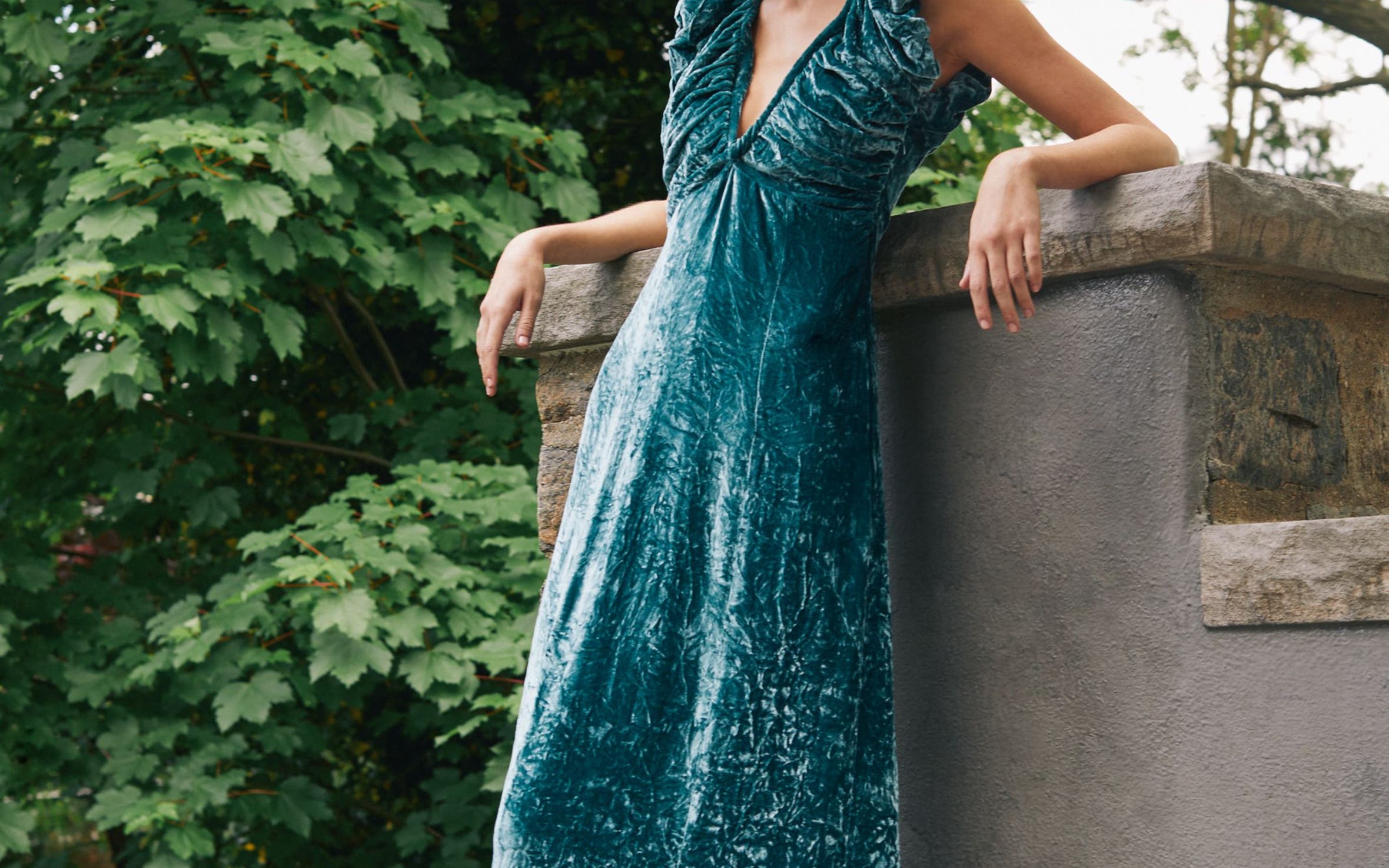 A woman in a teal velvet dress.