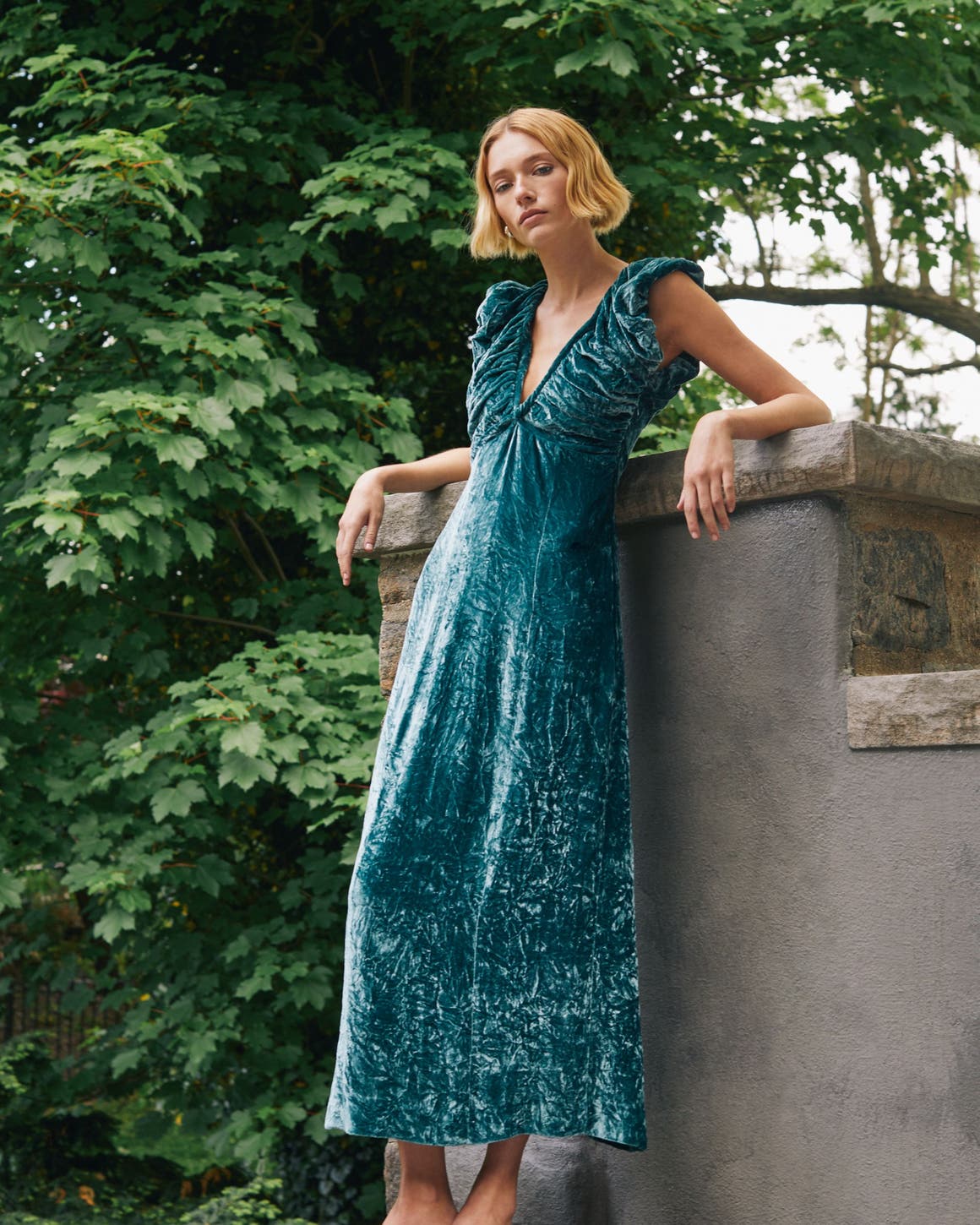 A woman in a teal velvet dress.