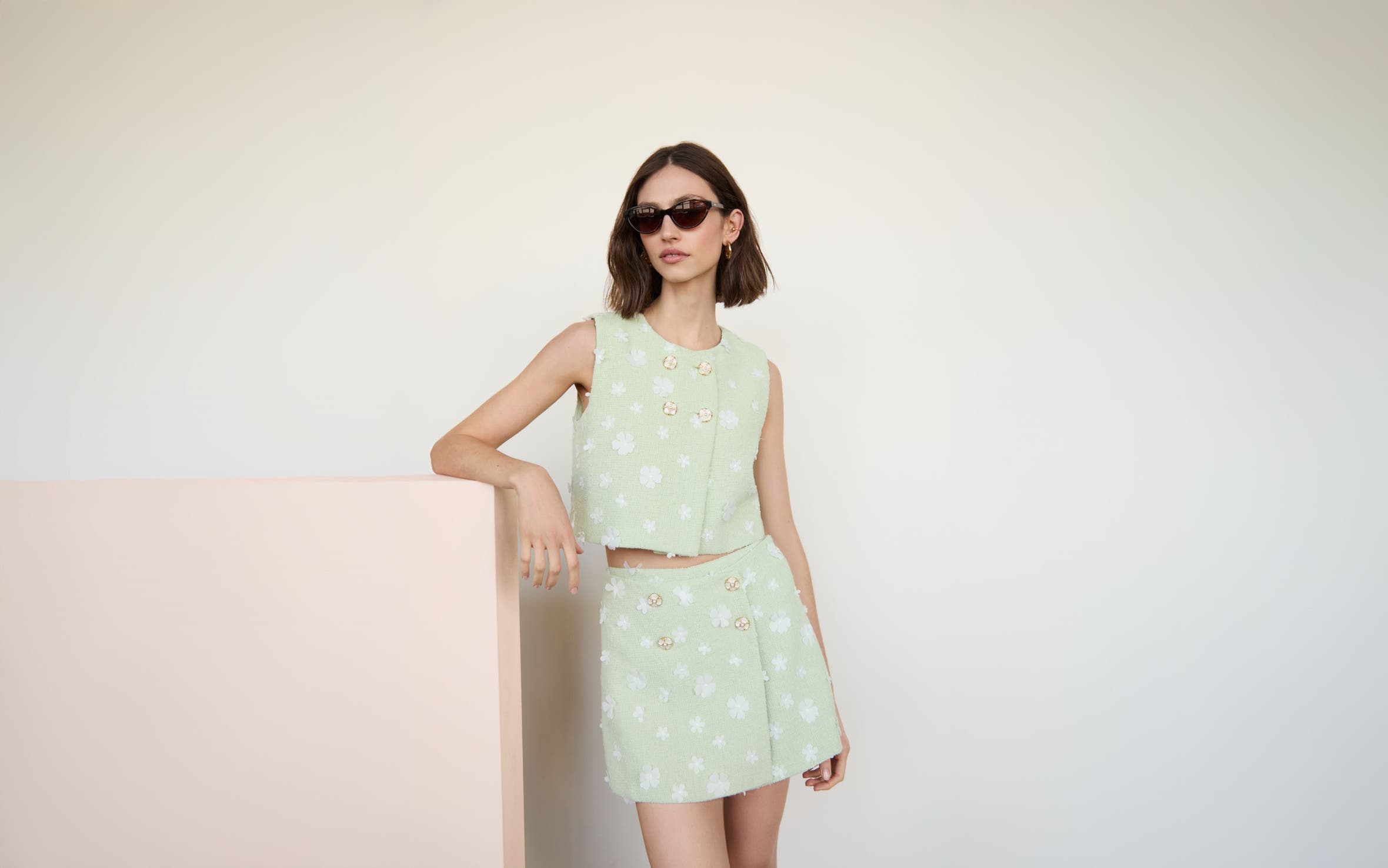 Woman wearing matching set and sunglasses.