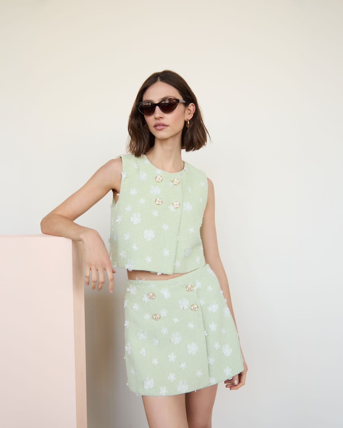 Woman wearing matching set and sunglasses.