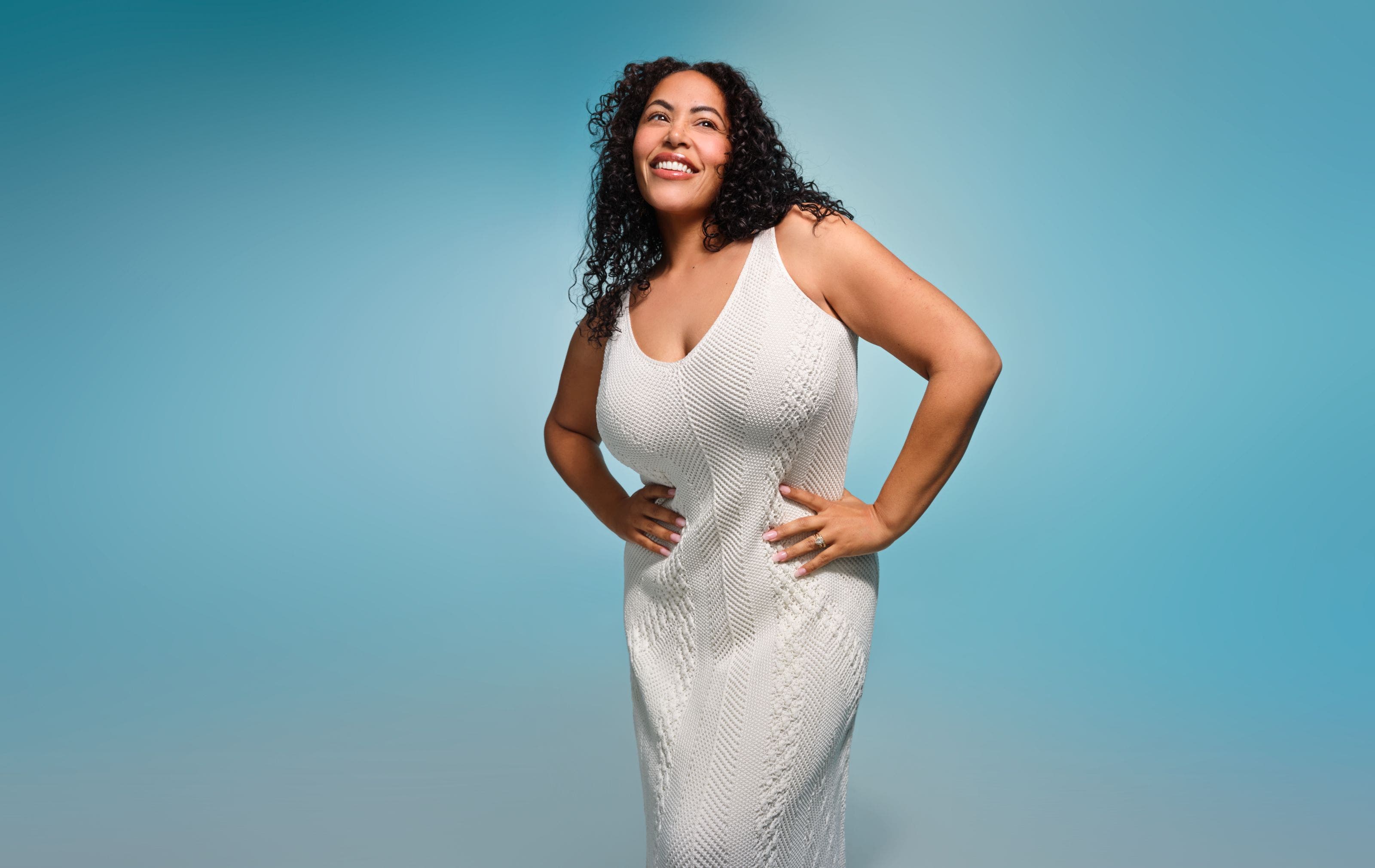 A woman wearing a white maxi dress.