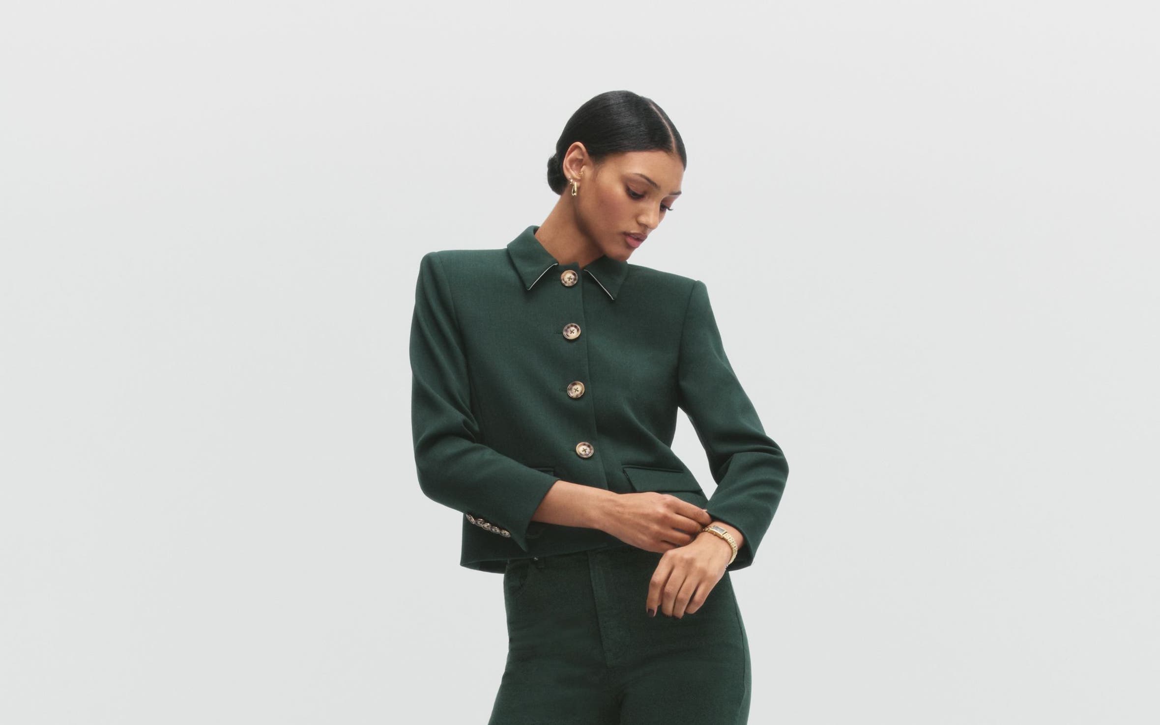 A woman wearing a green jacket and pants.
