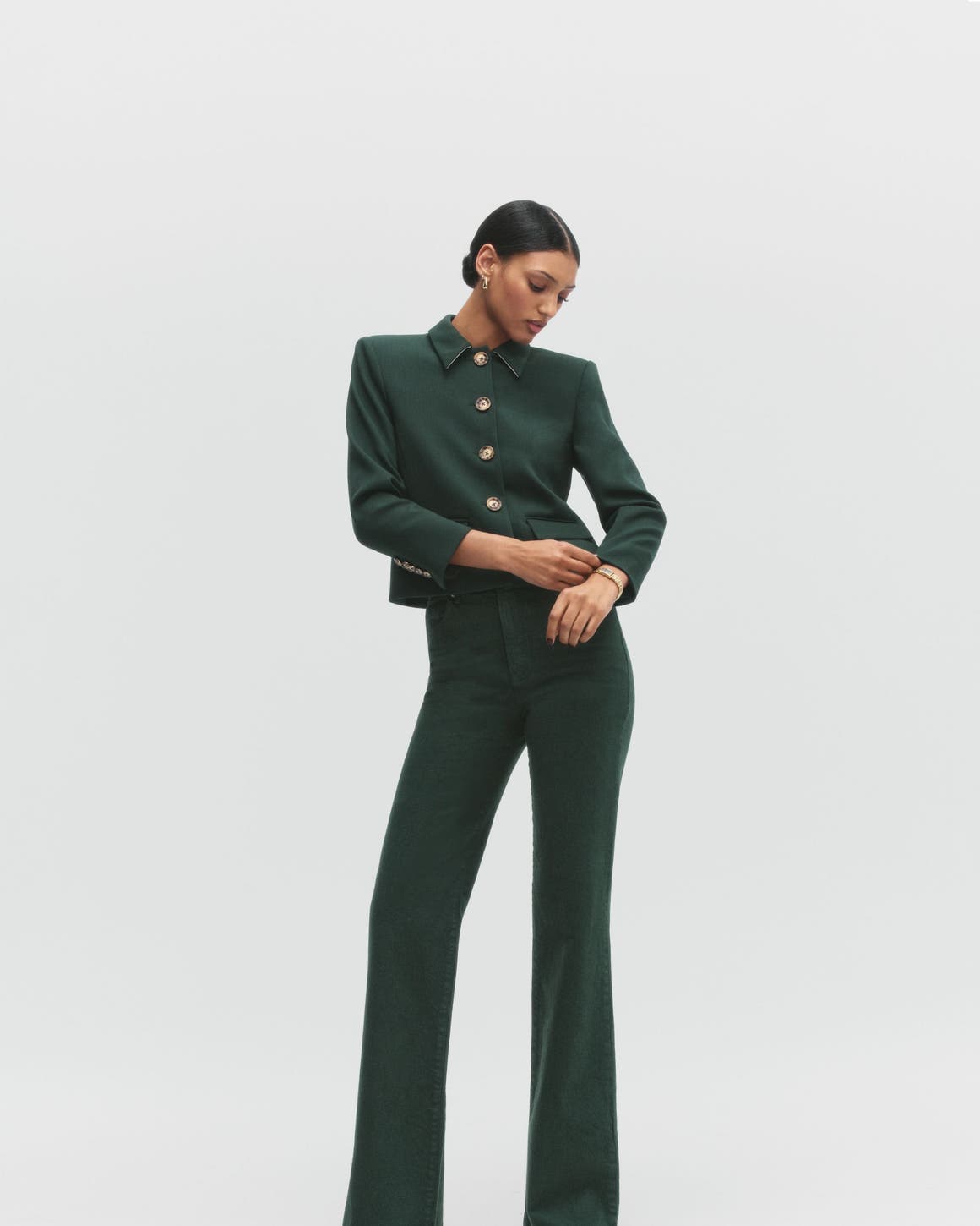 A woman wearing a green jacket and pants.