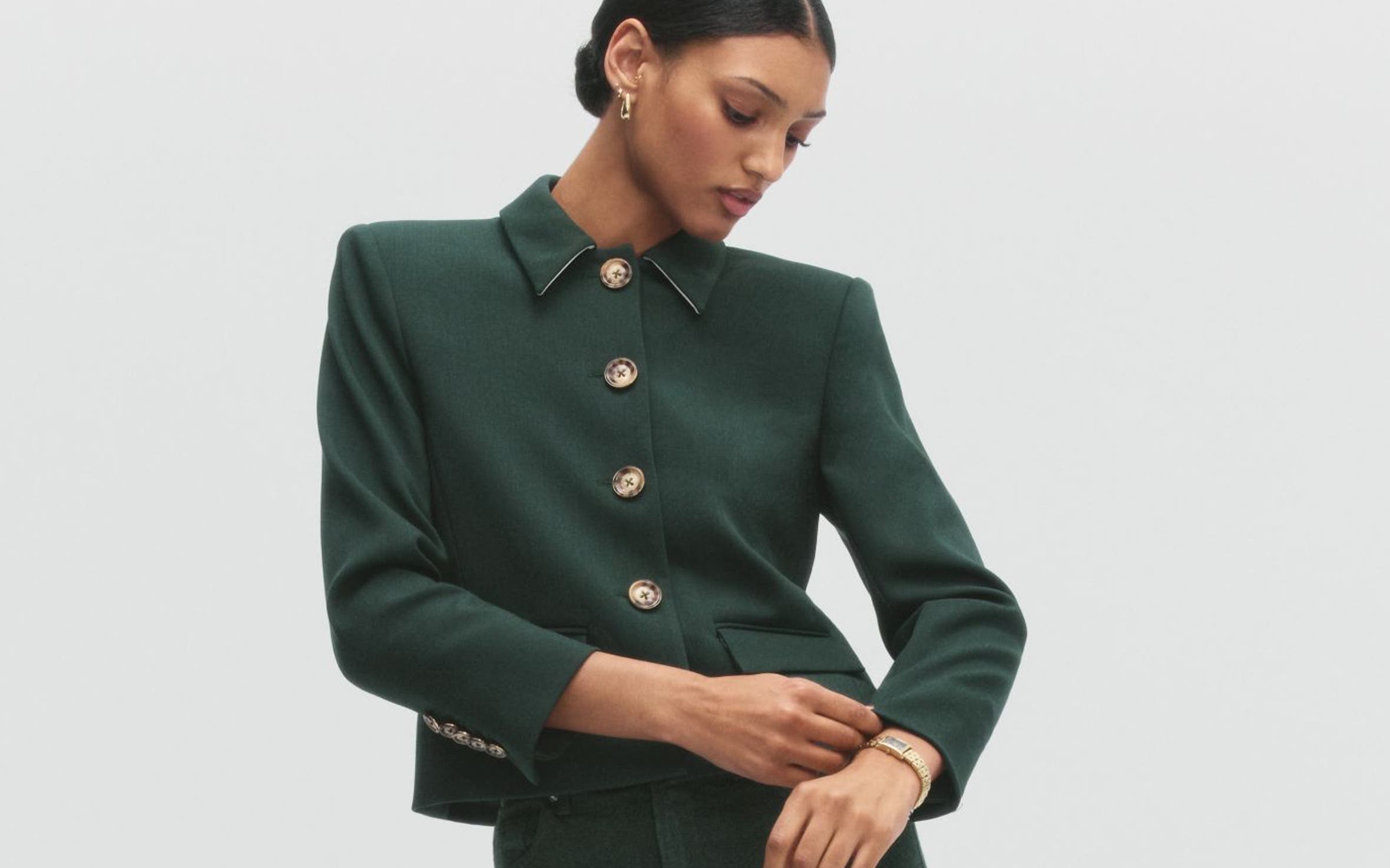 A woman wearing a green jacket and pants.