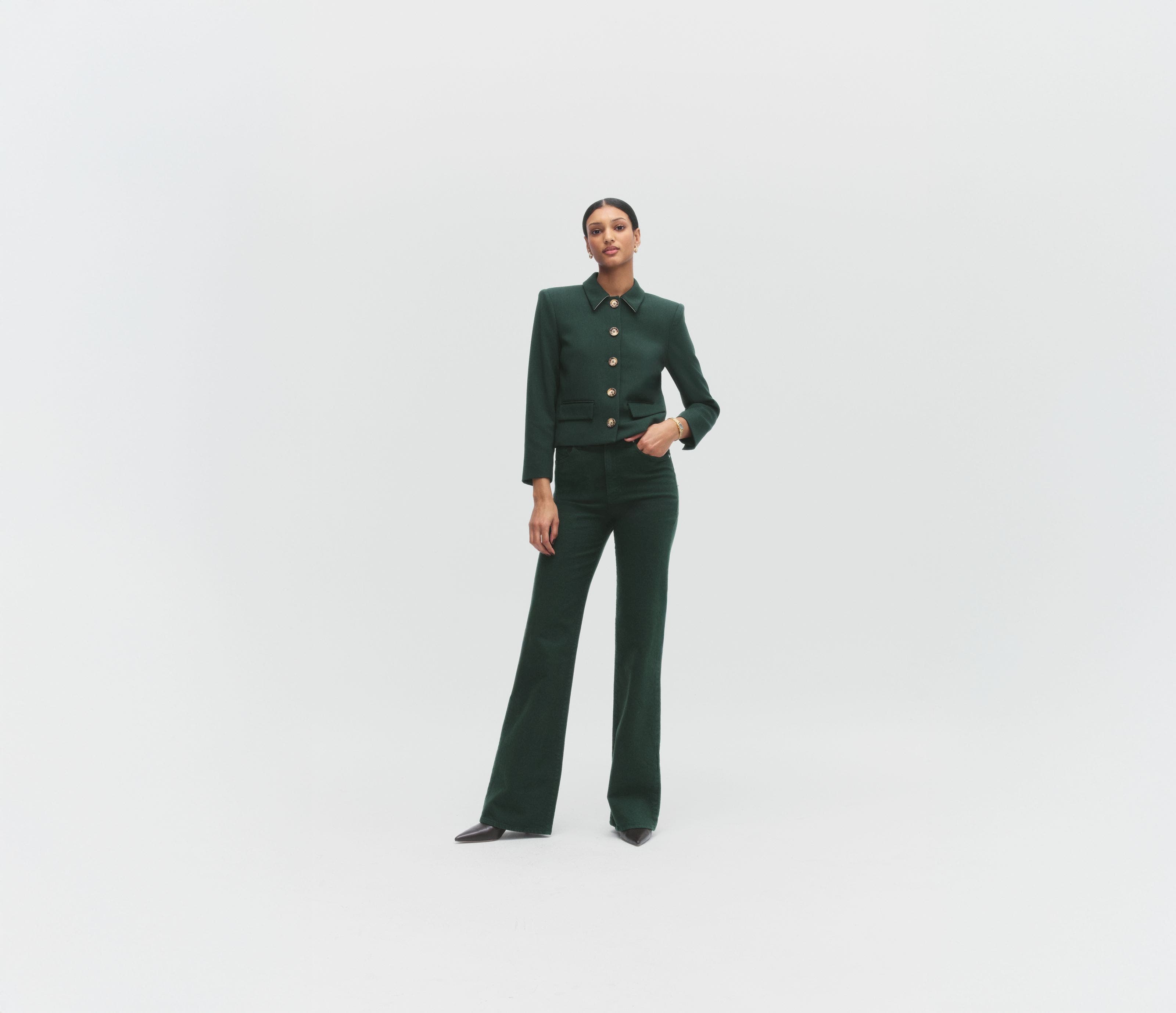 A woman wearing a green jacket and matching pants.