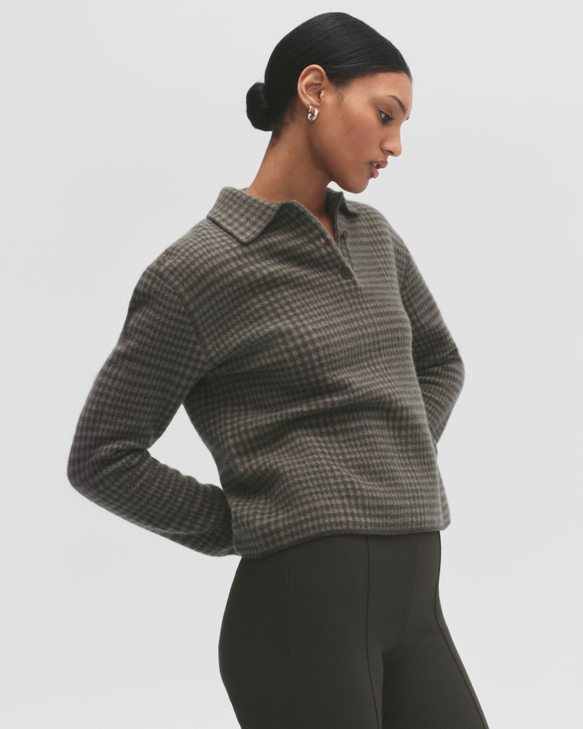 A woman wearing a plaid top.