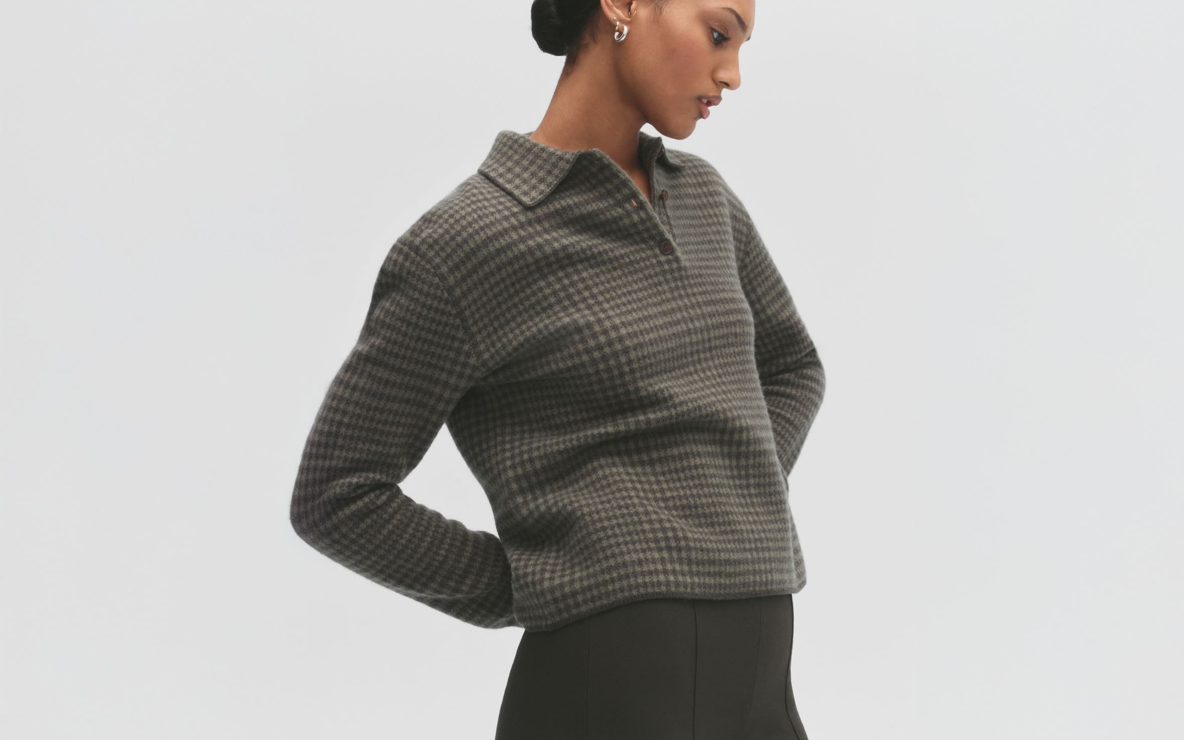 A woman wearing a plaid top.