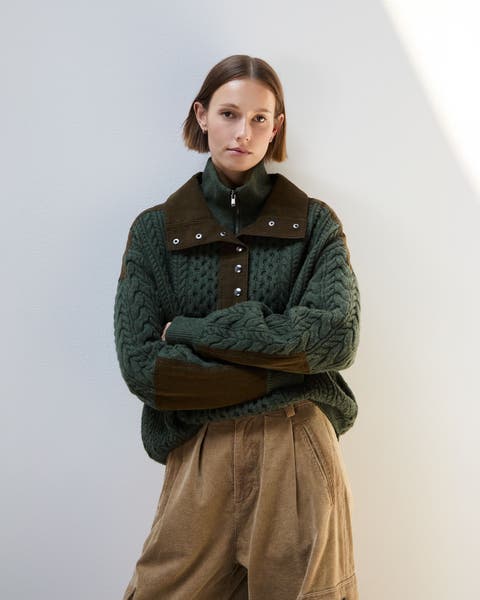 A woman wearing a chunky sweater.