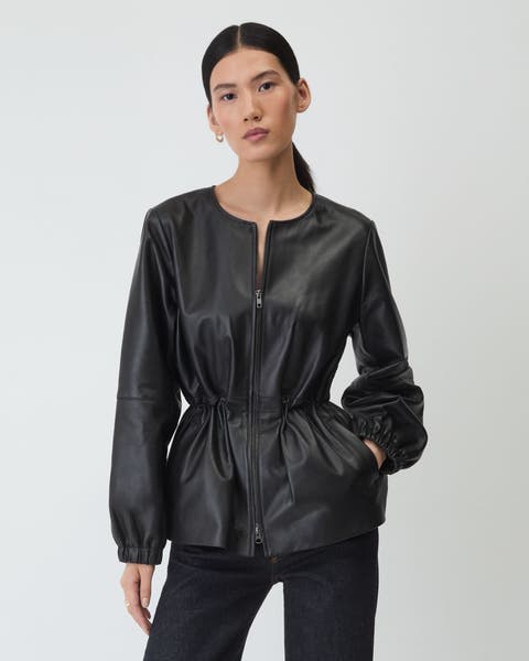 A woman wearing a long sleeve leather shirt.
