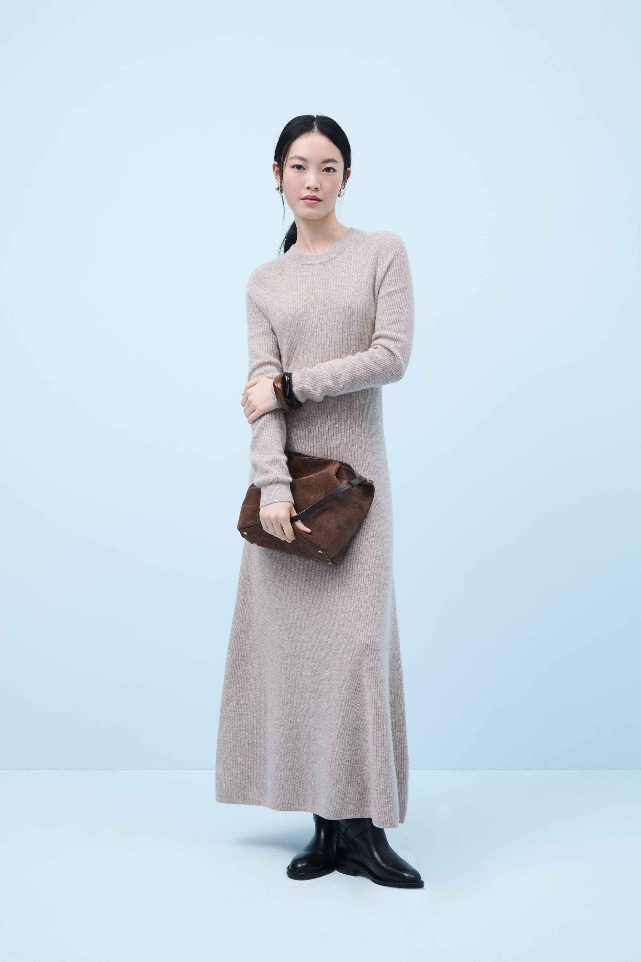 A woman wearing a maxi sweater dress.