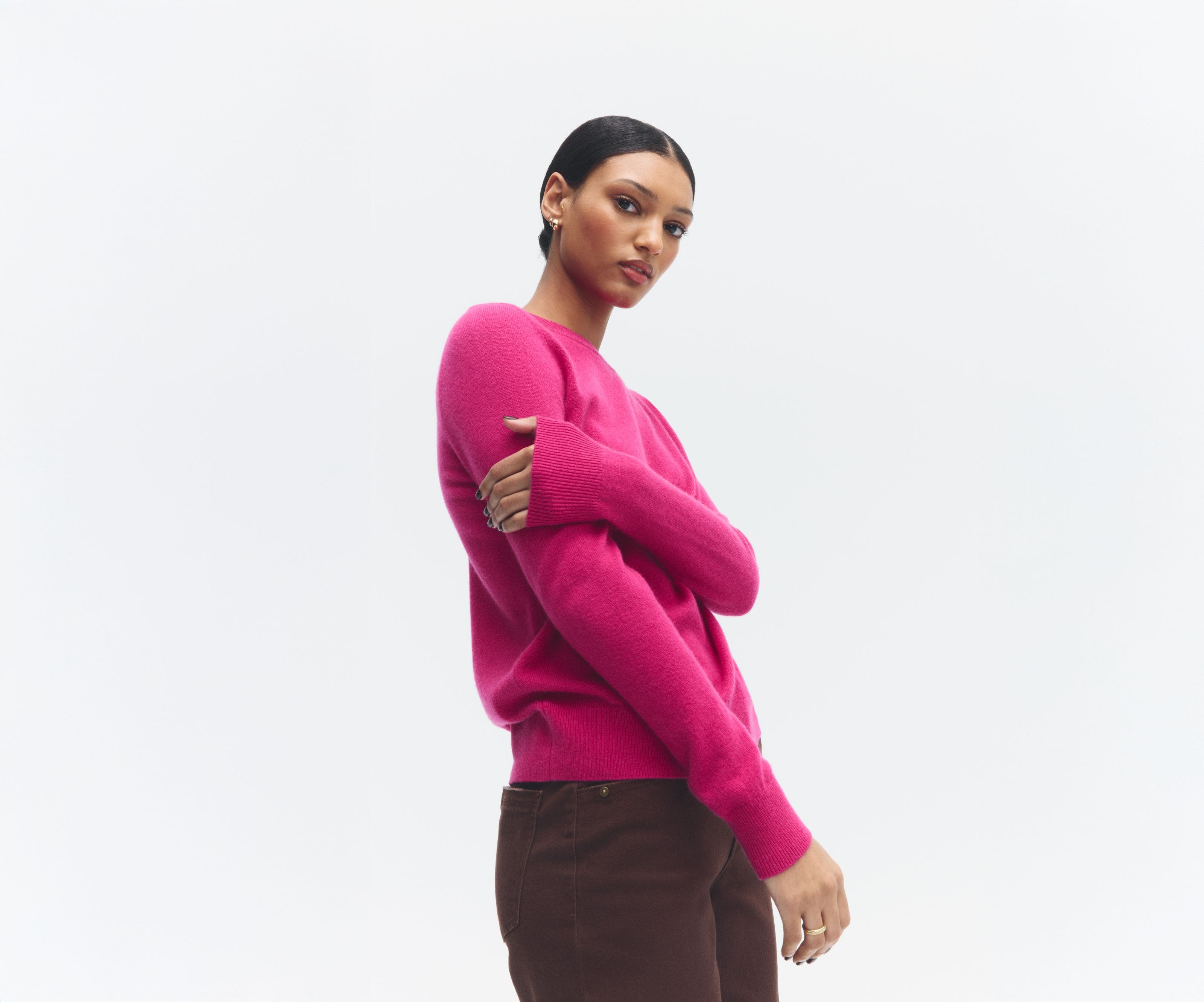 A woman wearing a pink sweater.