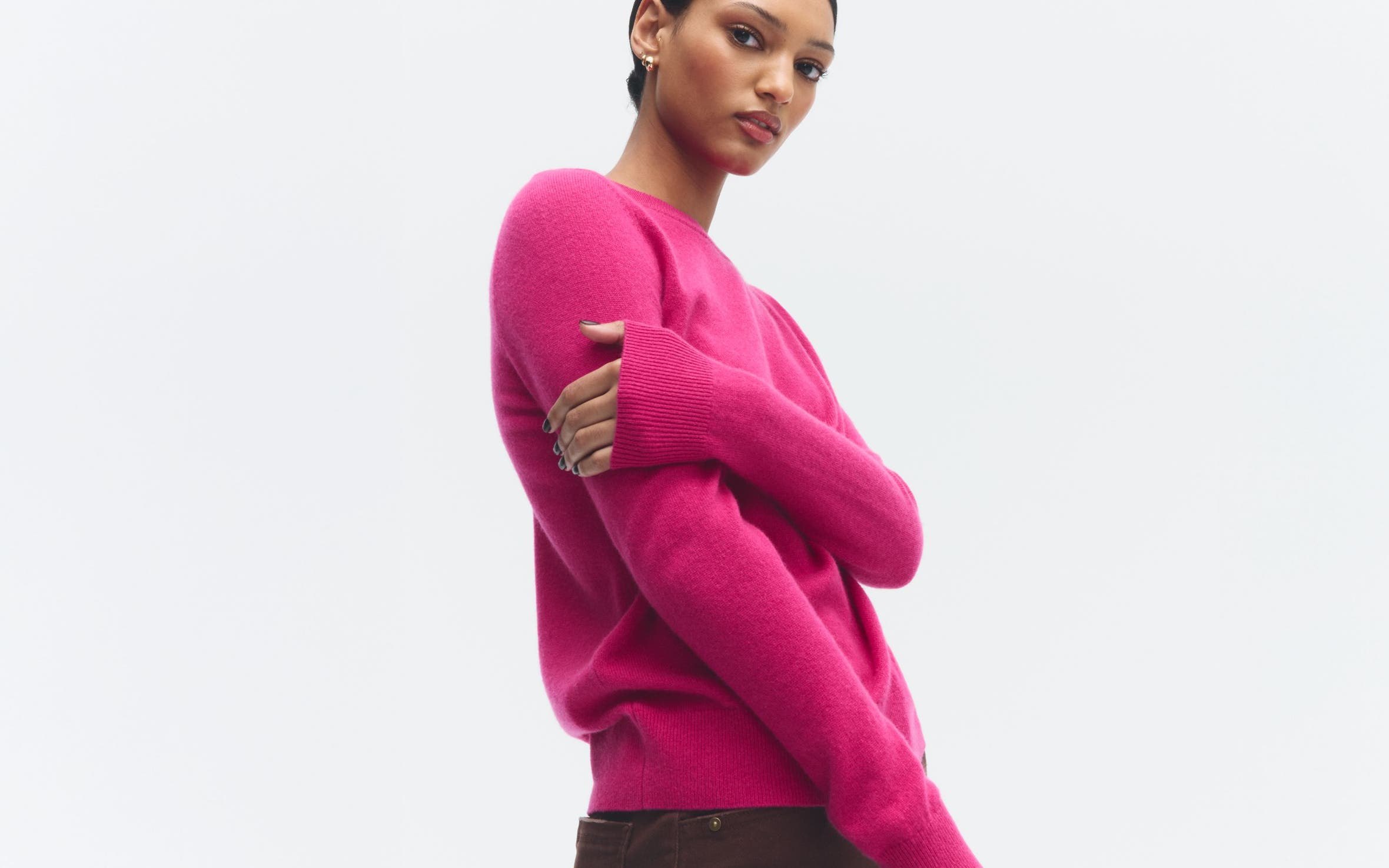 A woman wearing a pink sweater.