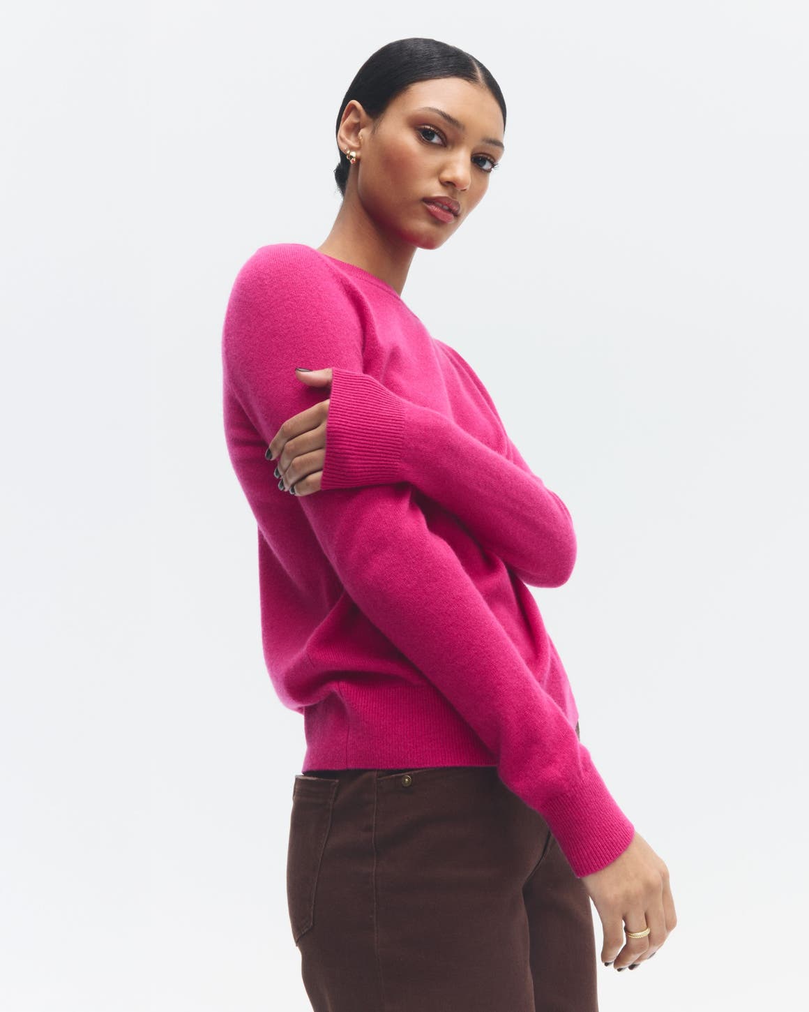 A woman wearing a pink sweater.