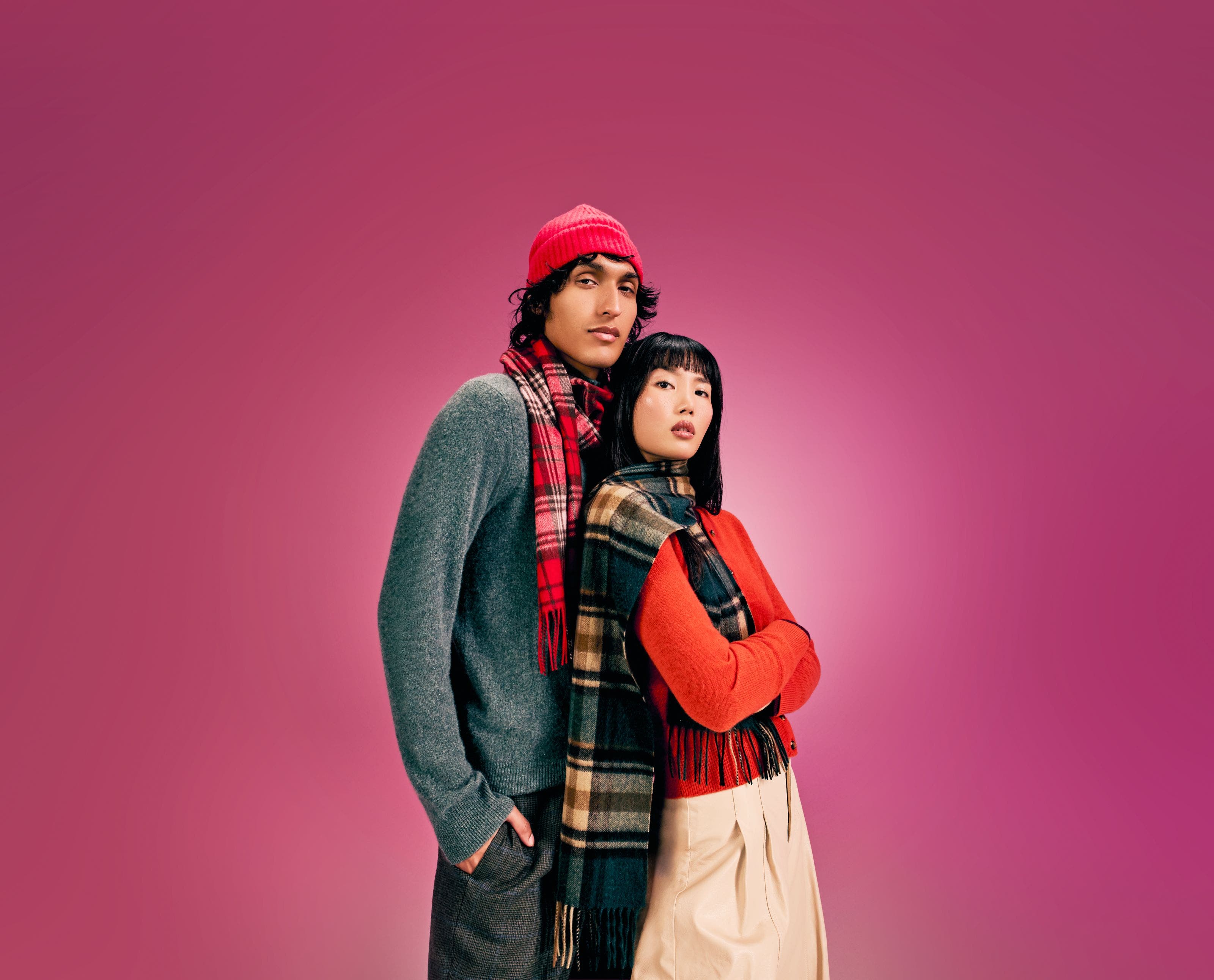 A man and a woman wearing cashmere sweaters.