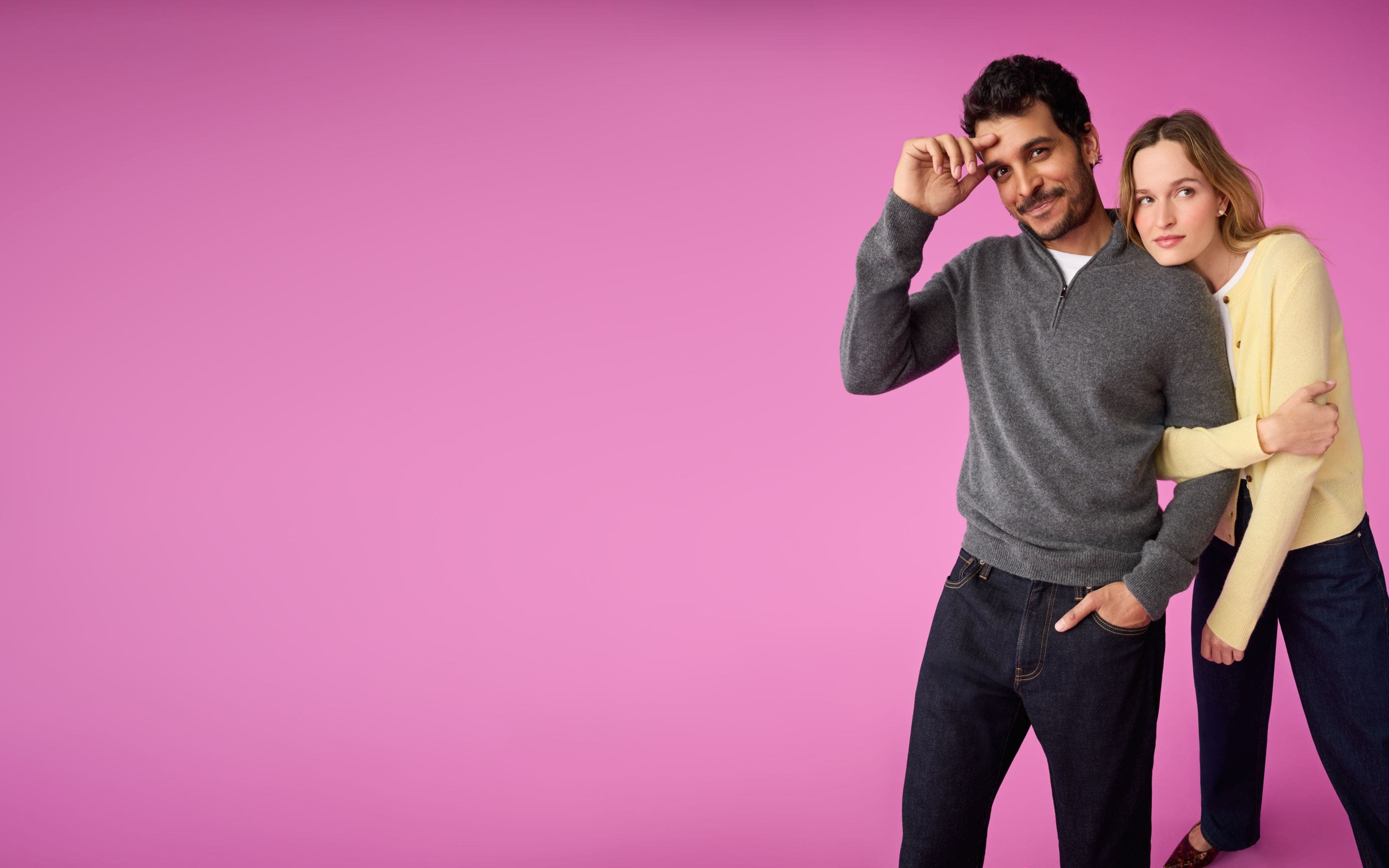 A man and a woman in sweaters and jeans.