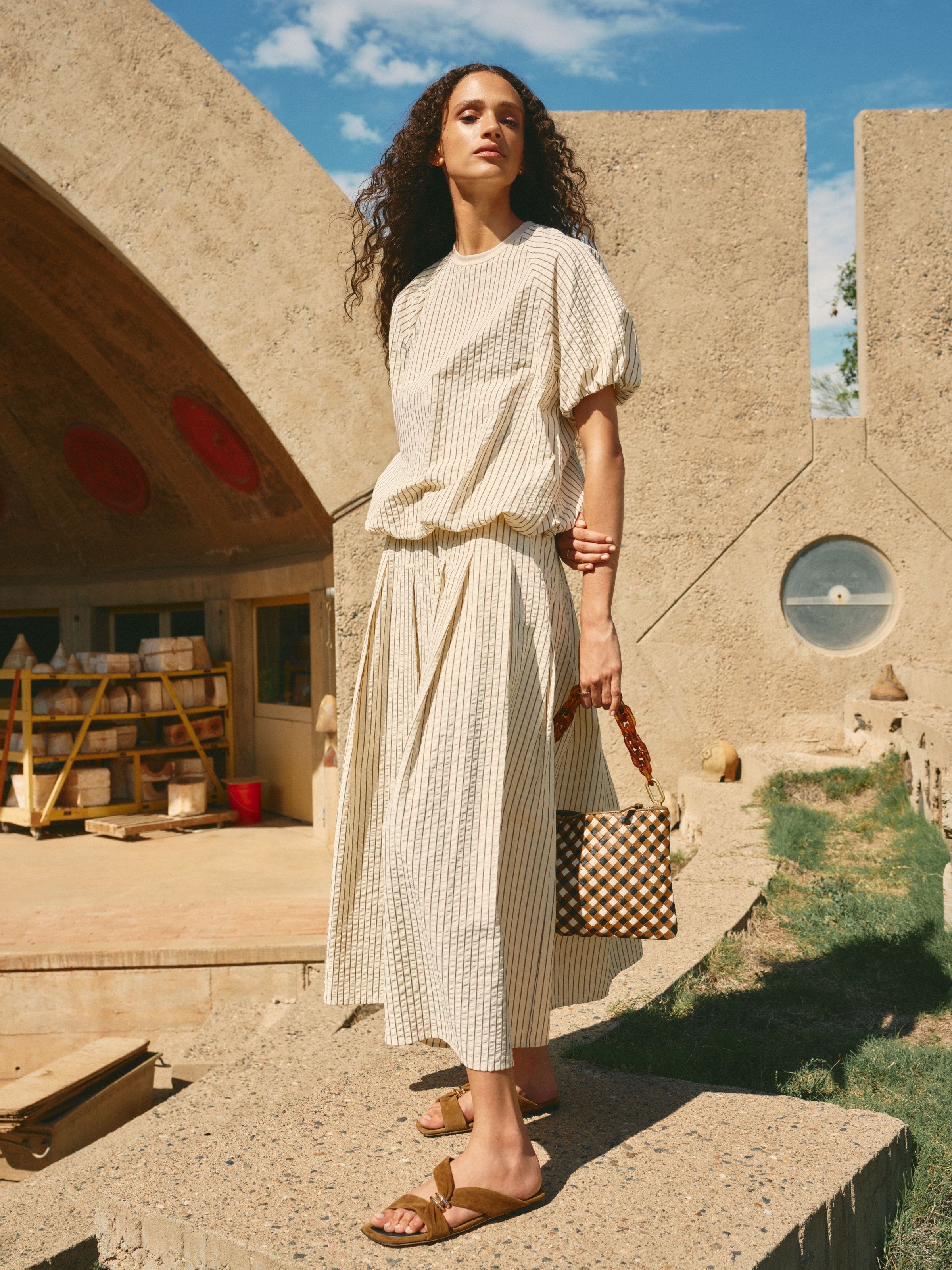 Woman wearing a breezy seersucker top and matching skirt.