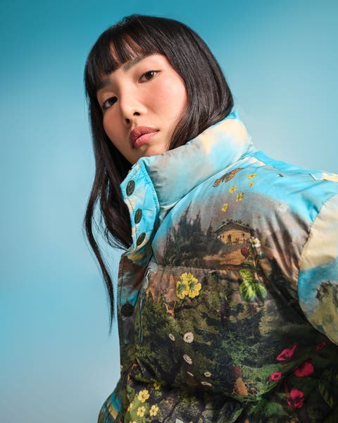 Woman wearing a colorful, printed puffer jacket.