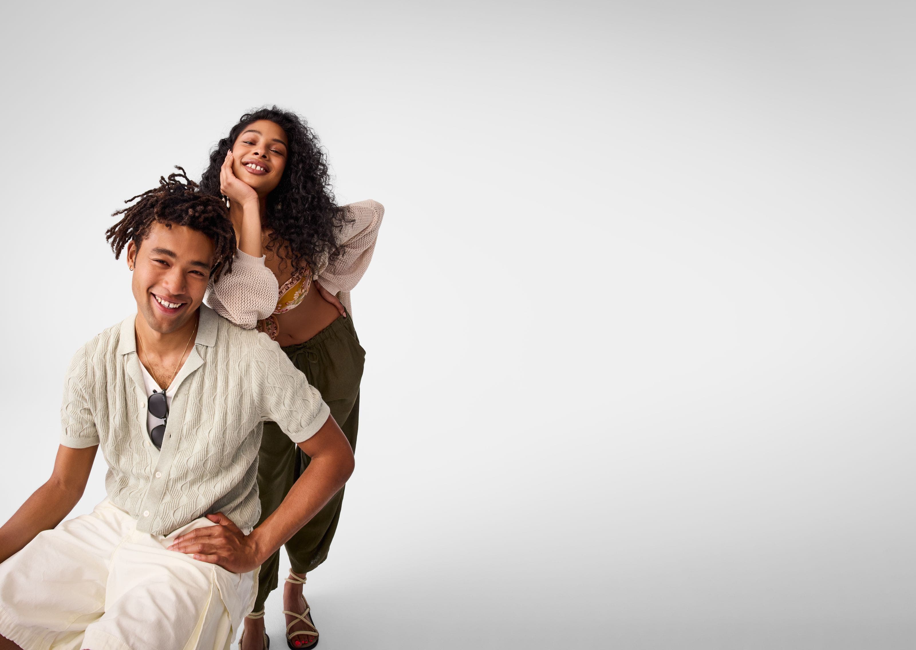 A woman and a man wearing warm-weather clothing.