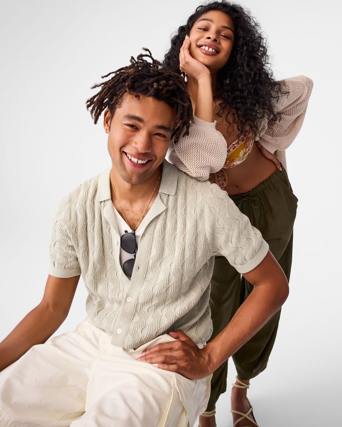 A woman and a man wearing warm-weather clothing.