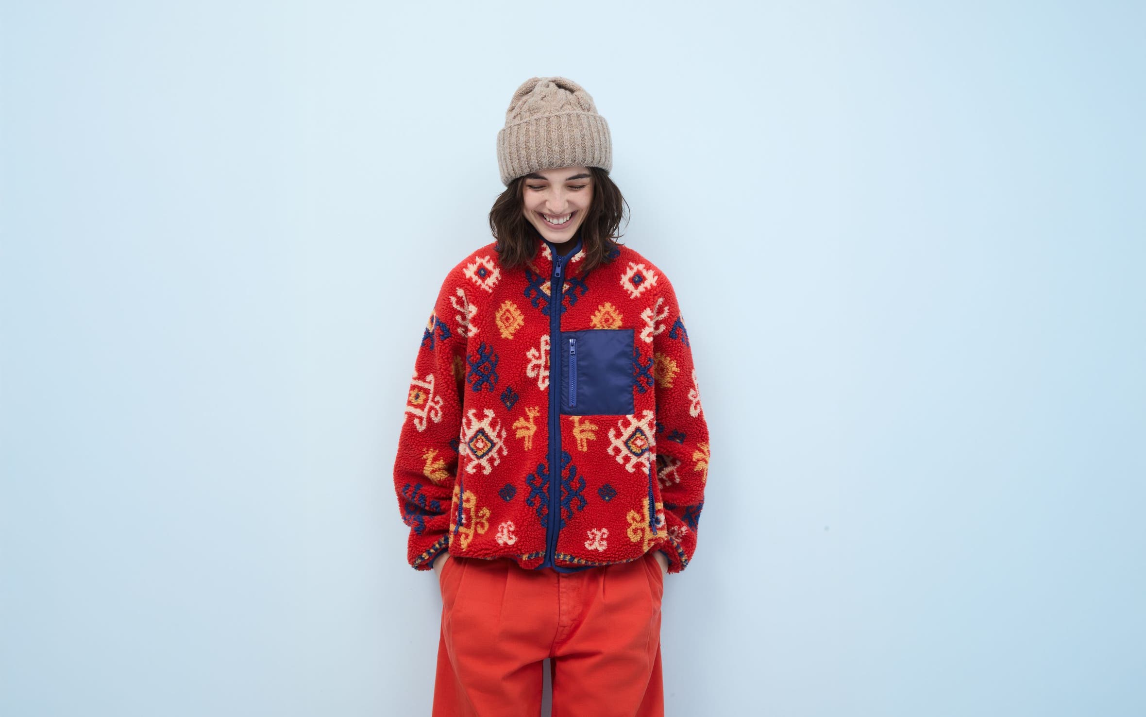 Woman wearing a fleece jacket, pants and beanie.