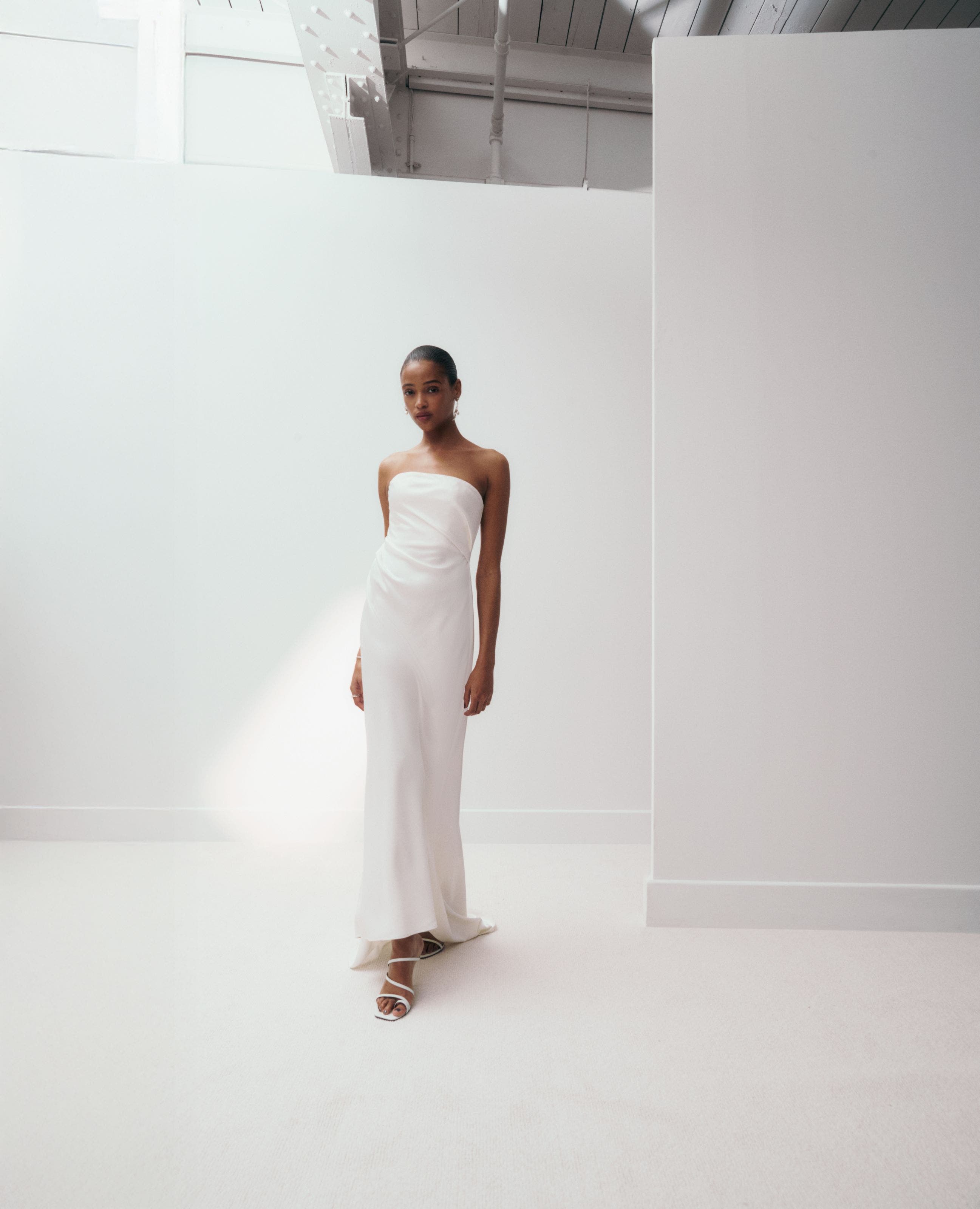 Woman wearing a strapless white gown.
