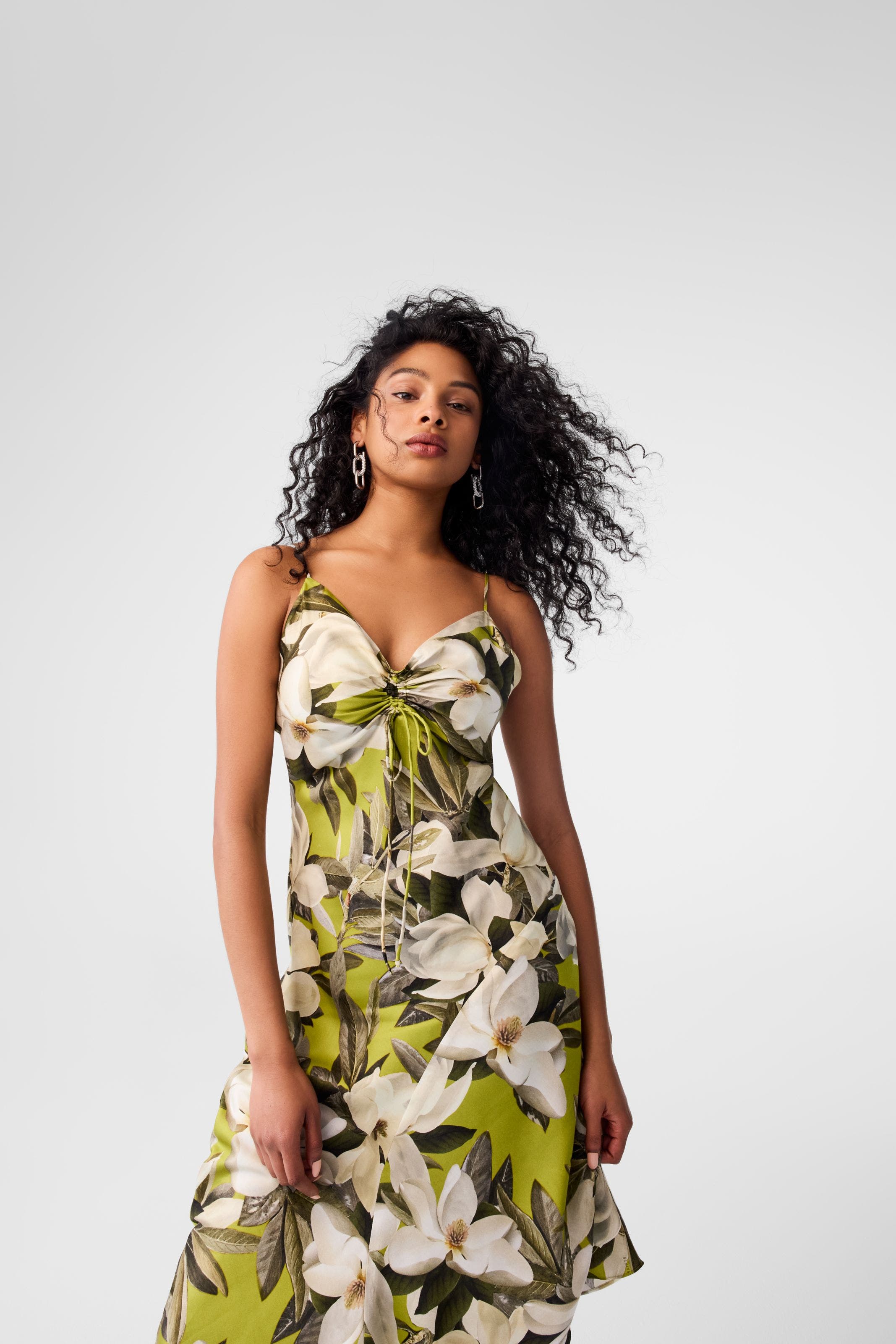 A woman wearing a floral sundress.