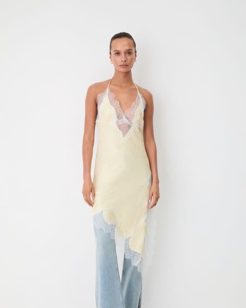 Woman wearing a lingerie style dress and jeans.