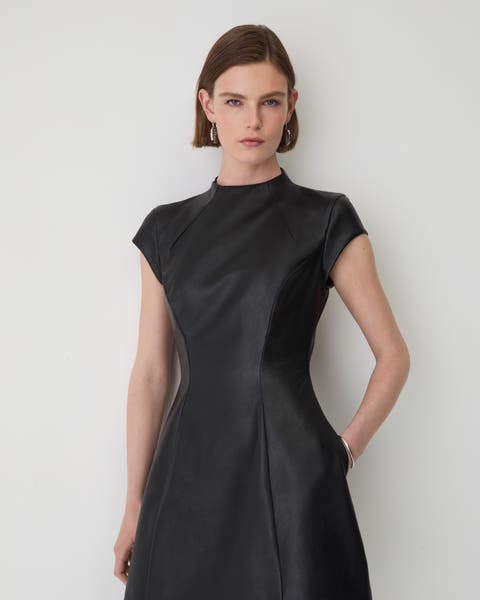 A woman wearing a leather dress.